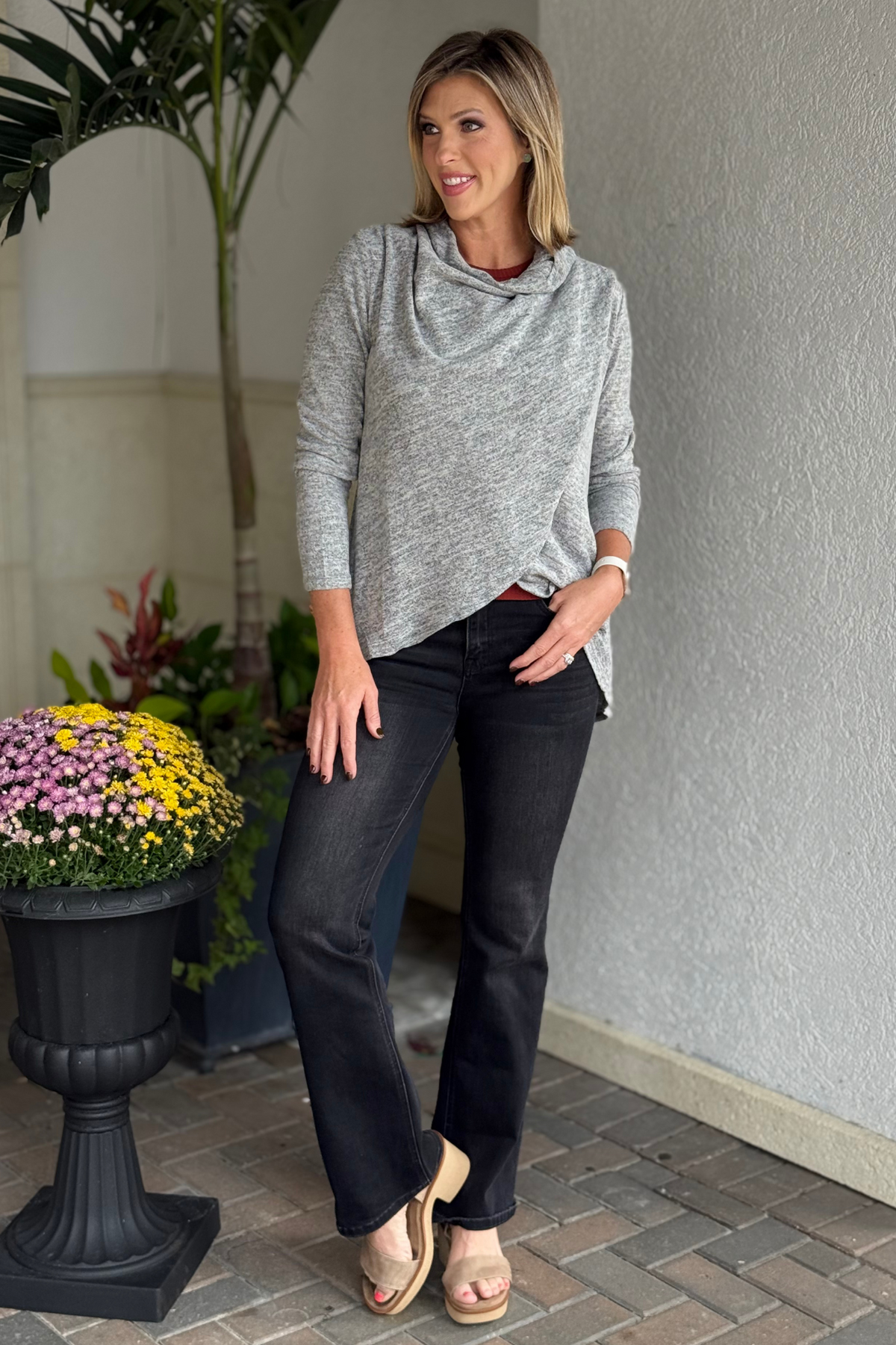 Woman wearing The Between Seasons Cardigan in charcoal black, styled as a buttoned sweater.