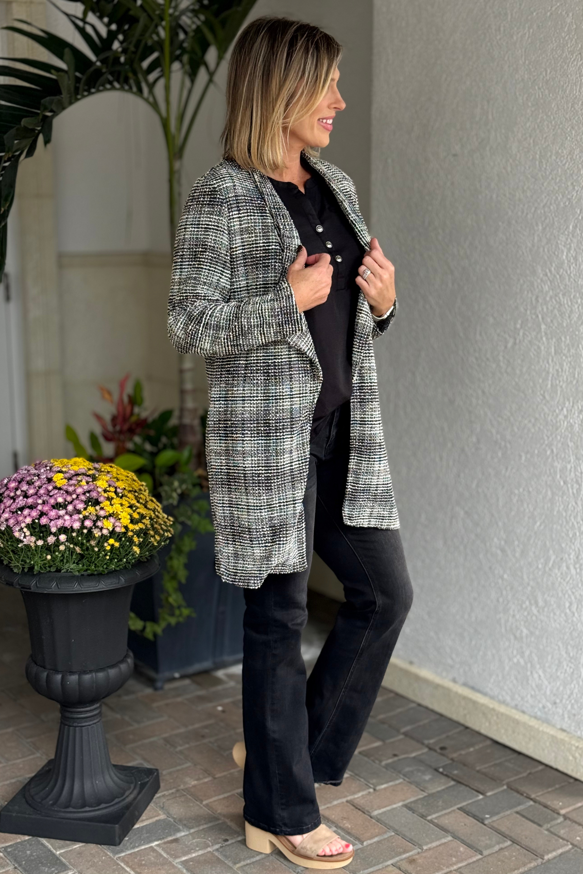 Side view of the TPN Brixton Tweed Midi Blazer showing open front and mid-length cut.