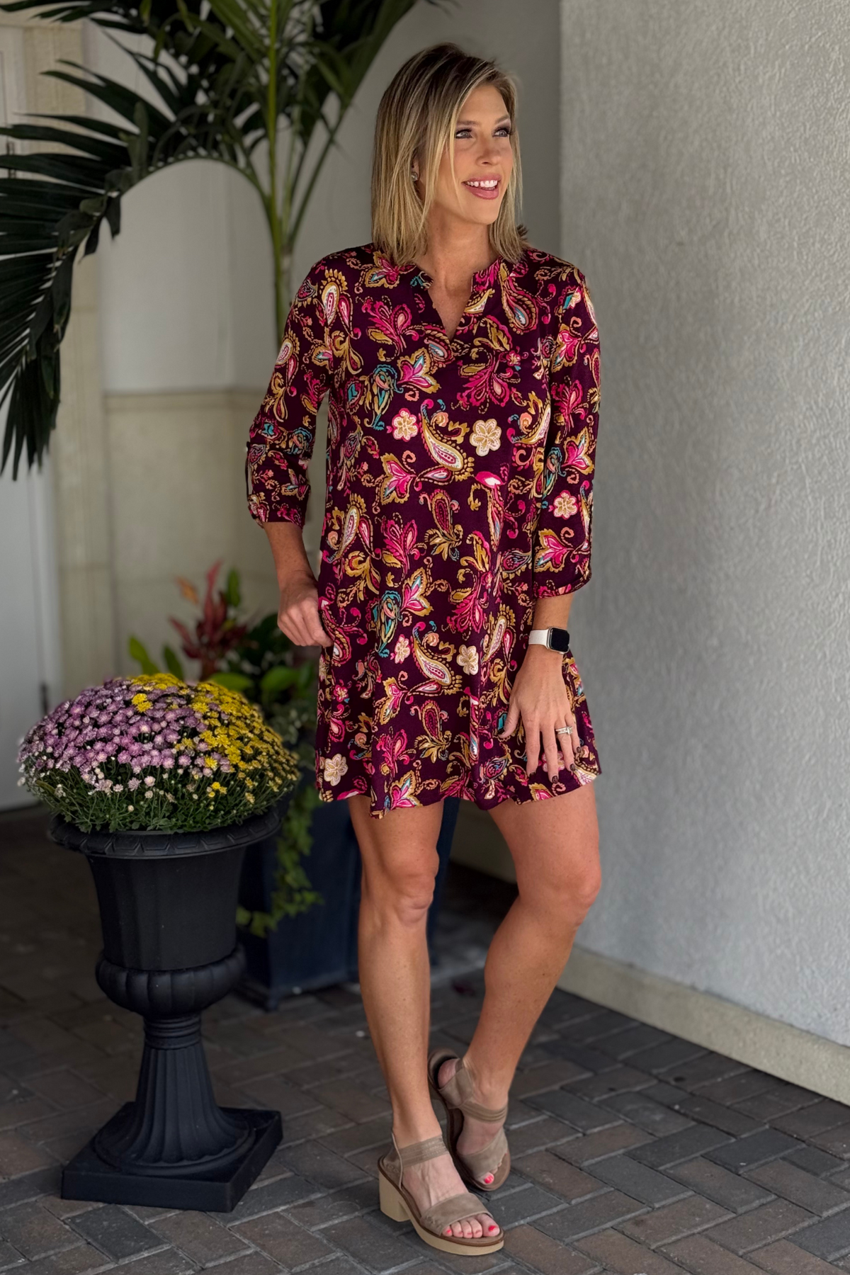 Woman wearing the TPN Merlot Paisley Lizzy Pocket Dress with rich wine background and colorful paisley print.
