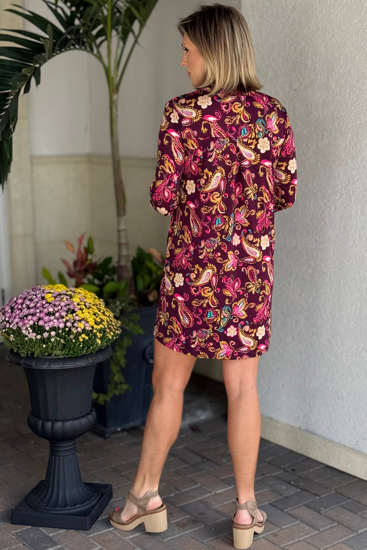 Close-up of wrinkle-free fabric and vibrant paisley pattern on the TPN Merlot Lizzy Dress.