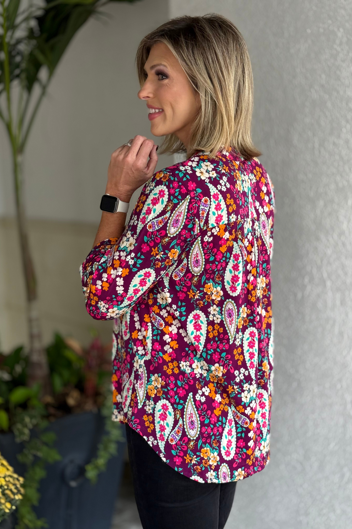 Side view showing the flowy high-low hemline of the TPN Berry Blossom Paisley Lizzy Top.