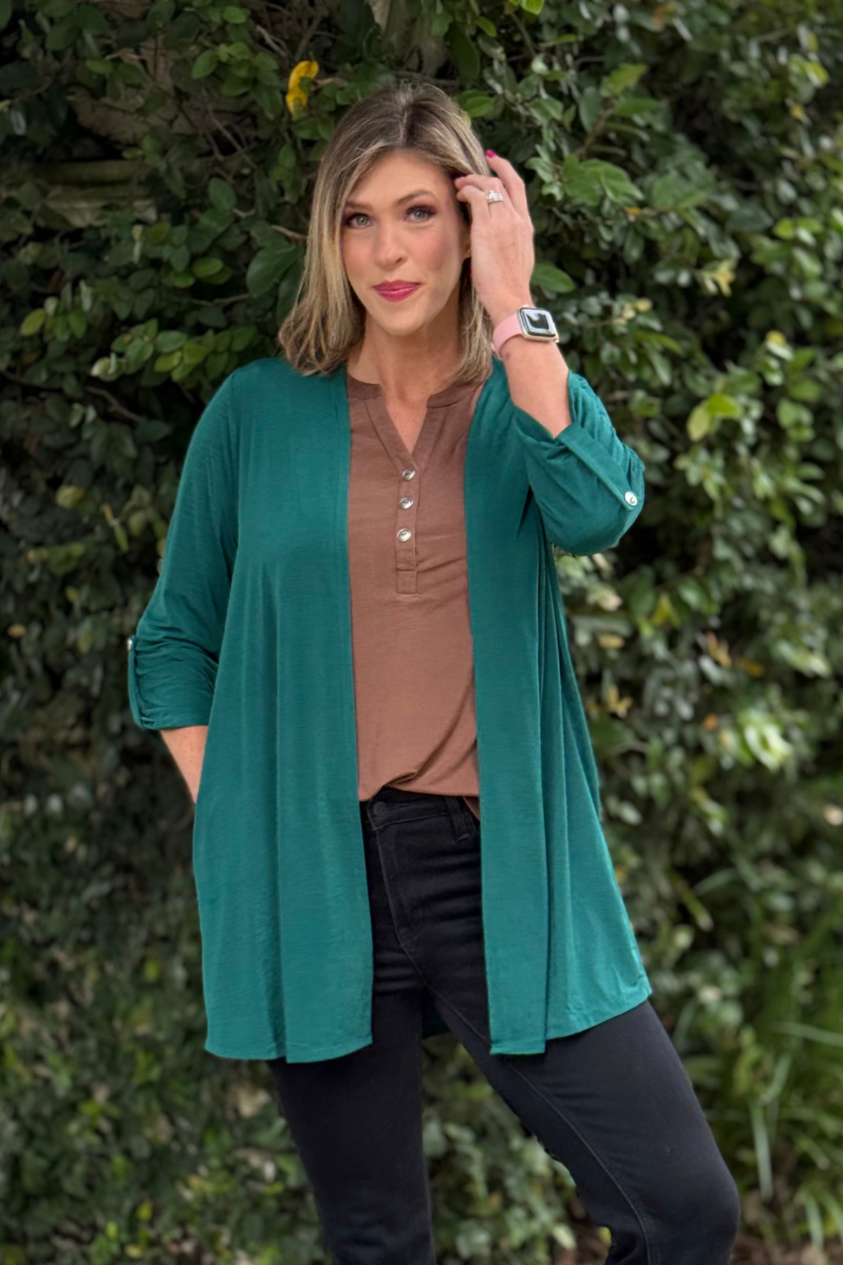 Model wearing TPN Jewel Essential Open Cardigan in Jewel Green made from wrinkle-free Bulgari fabric.
