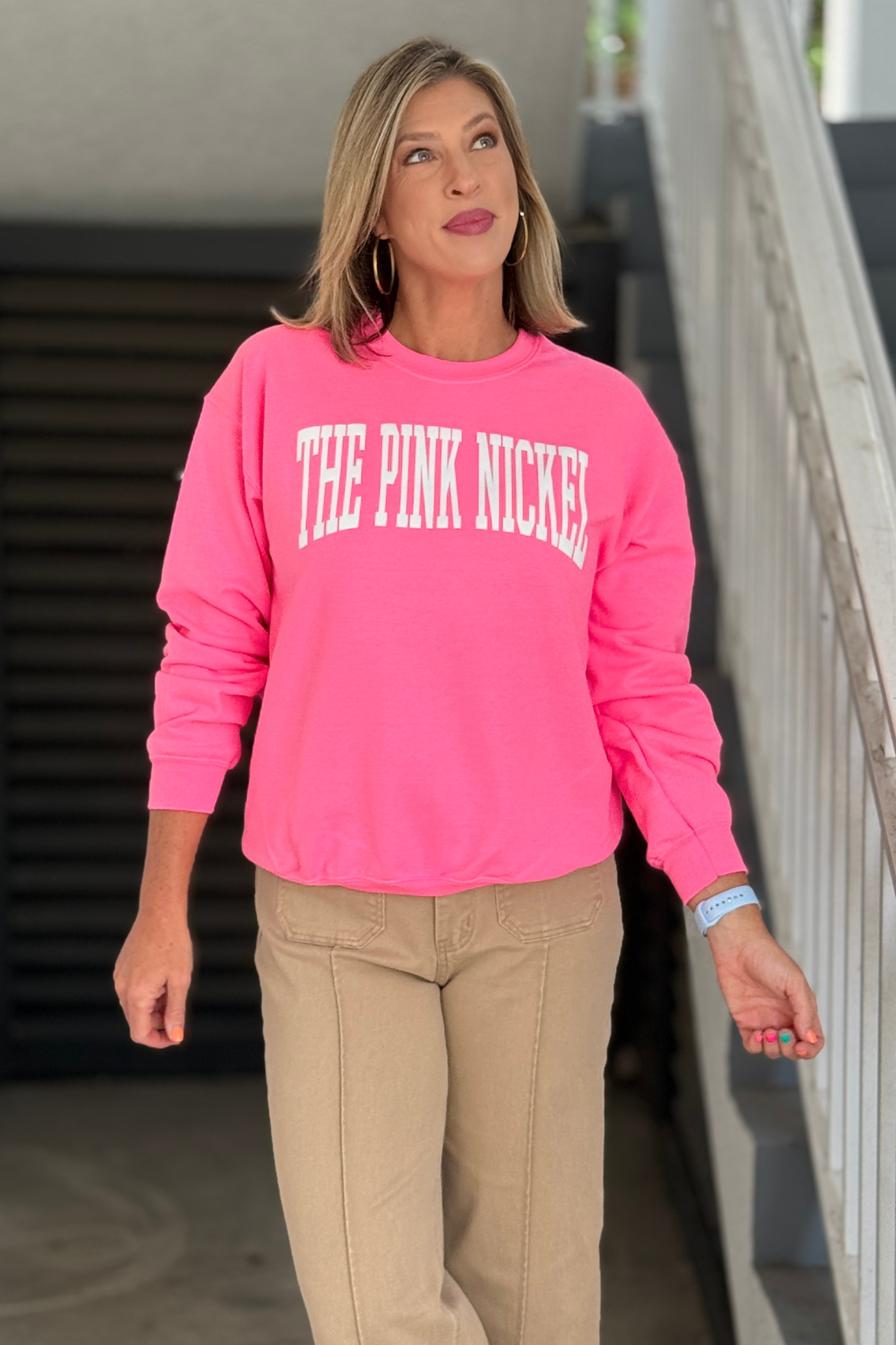 Hot pink crewneck sweatshirt with The Pink Nickel ivory lettering