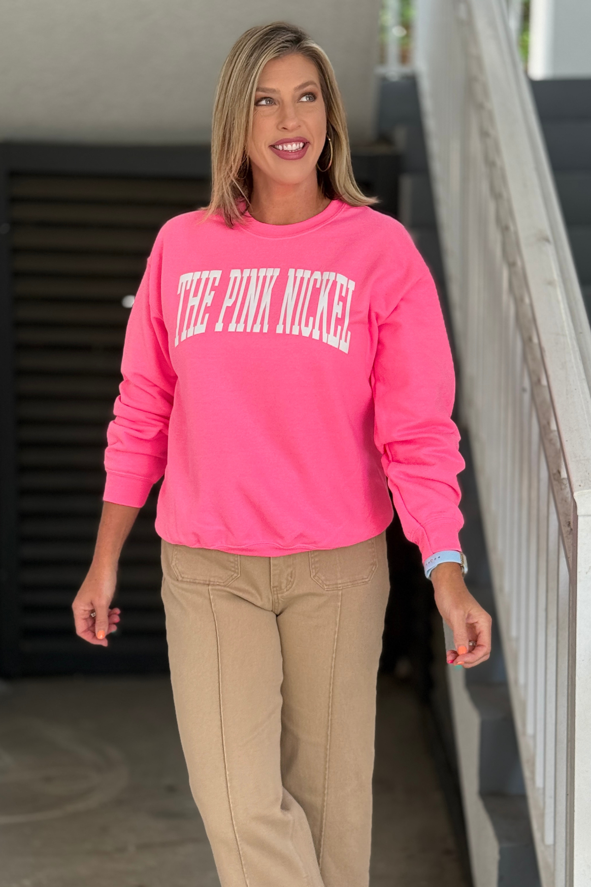 Back view of The Pink Nickel hot pink crewneck sweatshirt