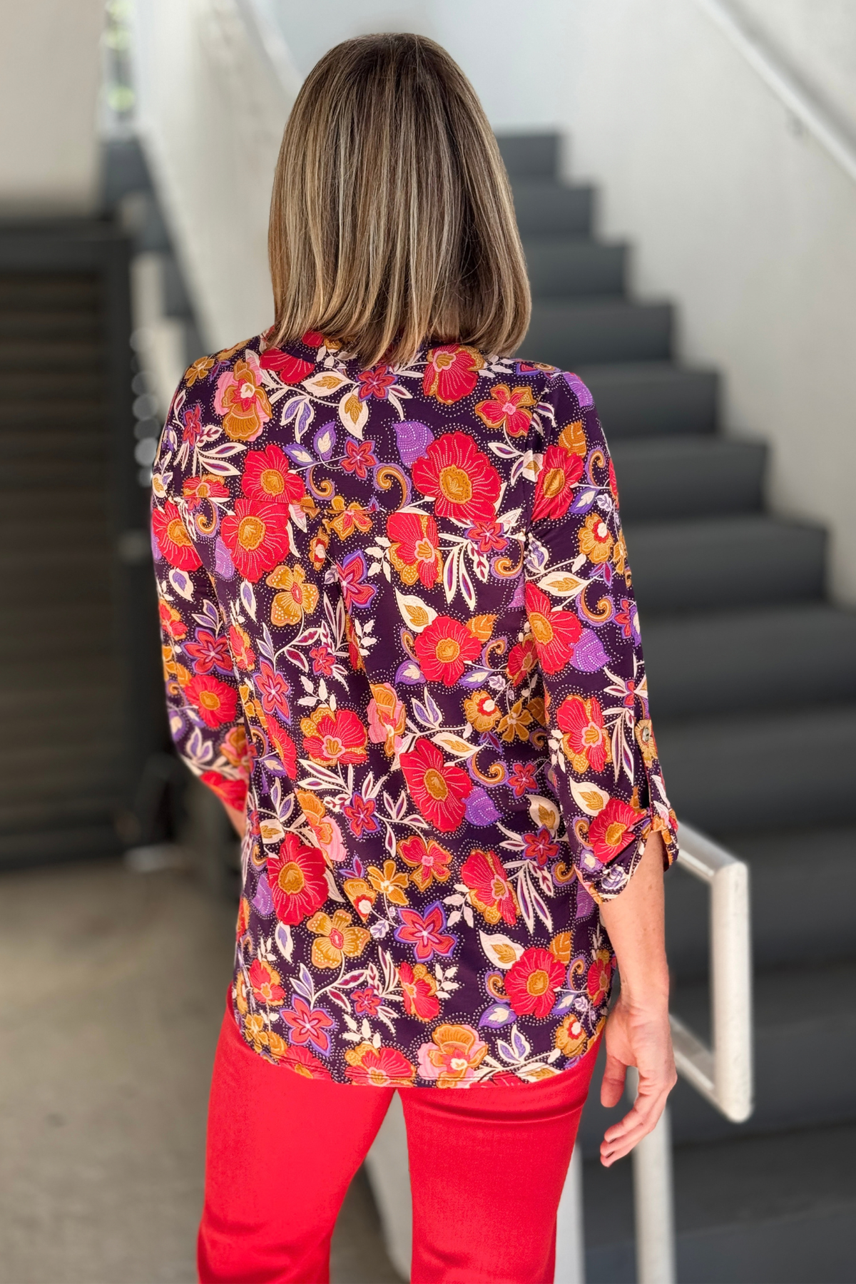 Eggplant floral print top styled with red pants