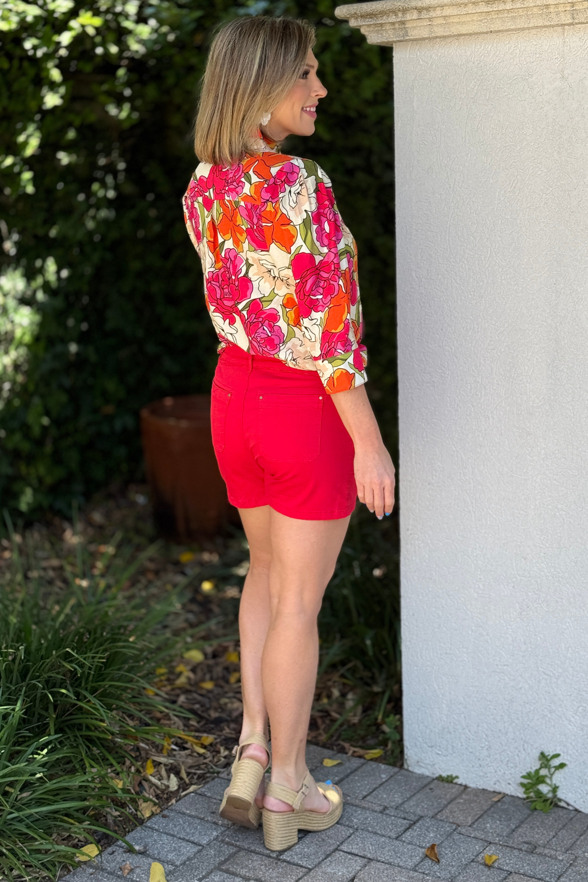 bright red shorts styled with floral top