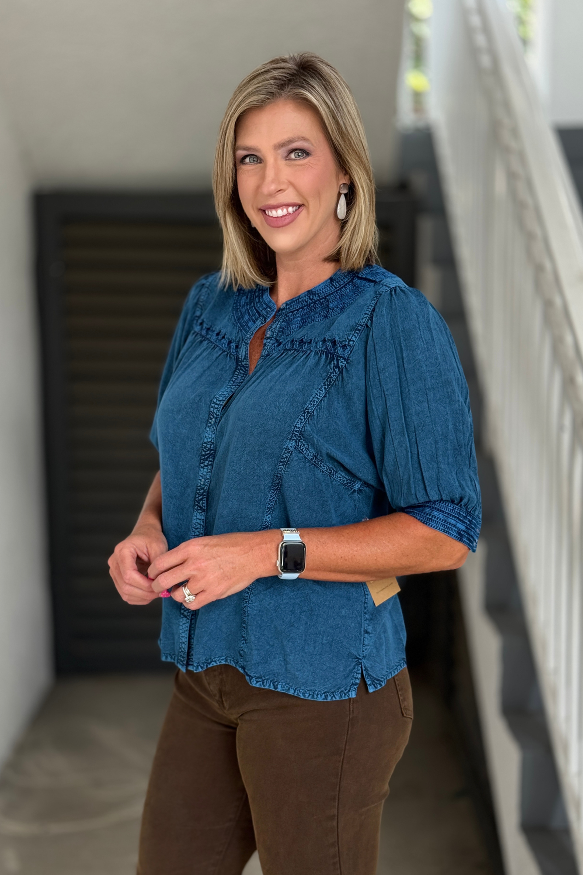 Woman wearing the Tru Luxe Blue Embroidered Button Front Rayon Top with stand collar, embroidered details, and elbow-length sleeves.