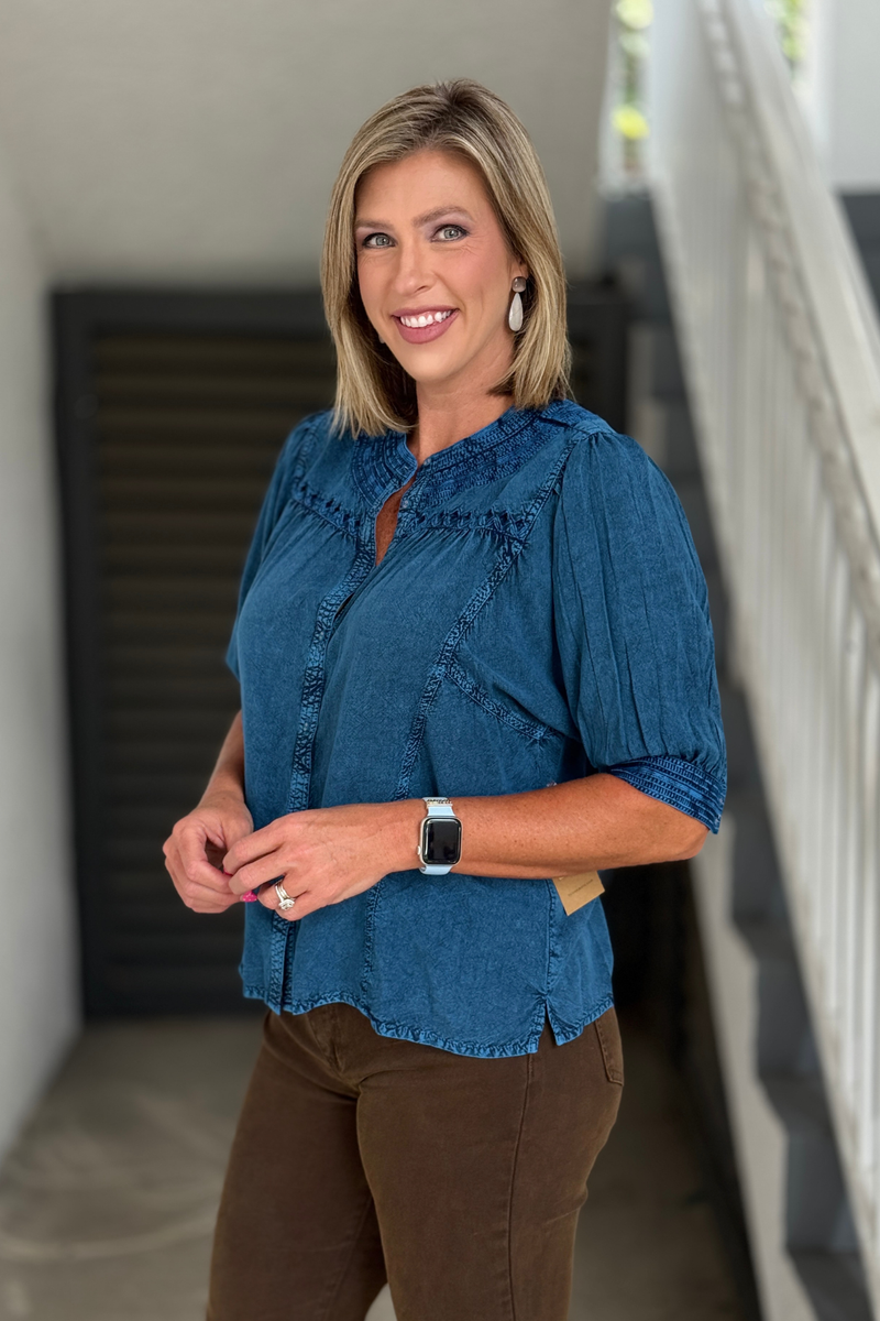 Woman wearing the Tru Luxe Blue Embroidered Button Front Rayon Top with stand collar, embroidered details, and elbow-length sleeves.