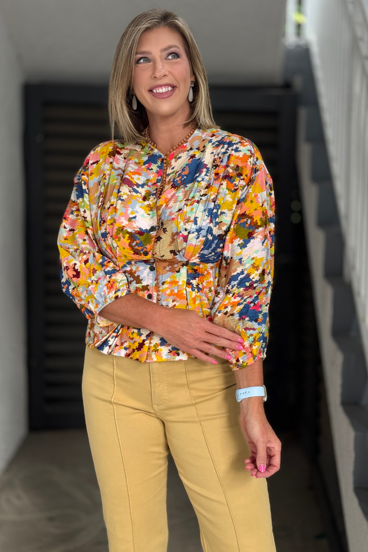 Front view of the TRU LUXE printed blouse featuring a cinched waist, button front, and lantern sleeves.