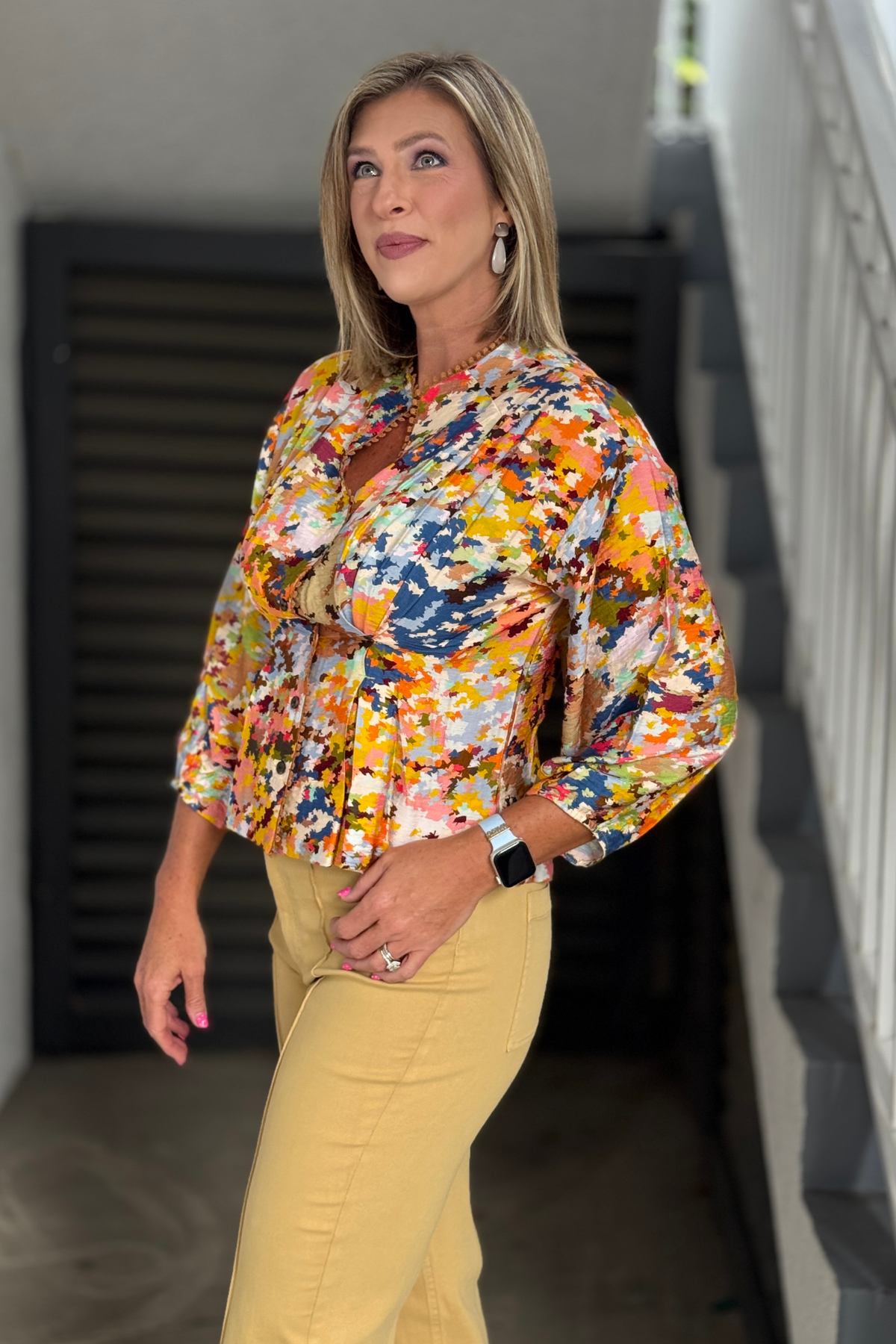 Side view of the colorful women's printed blouse showing the flattering waist detail and flowing fit.
