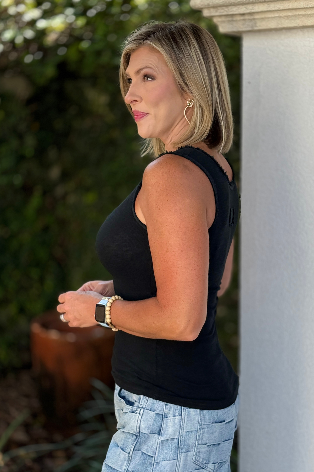 Black sleeveless tank top with raw edge neckline