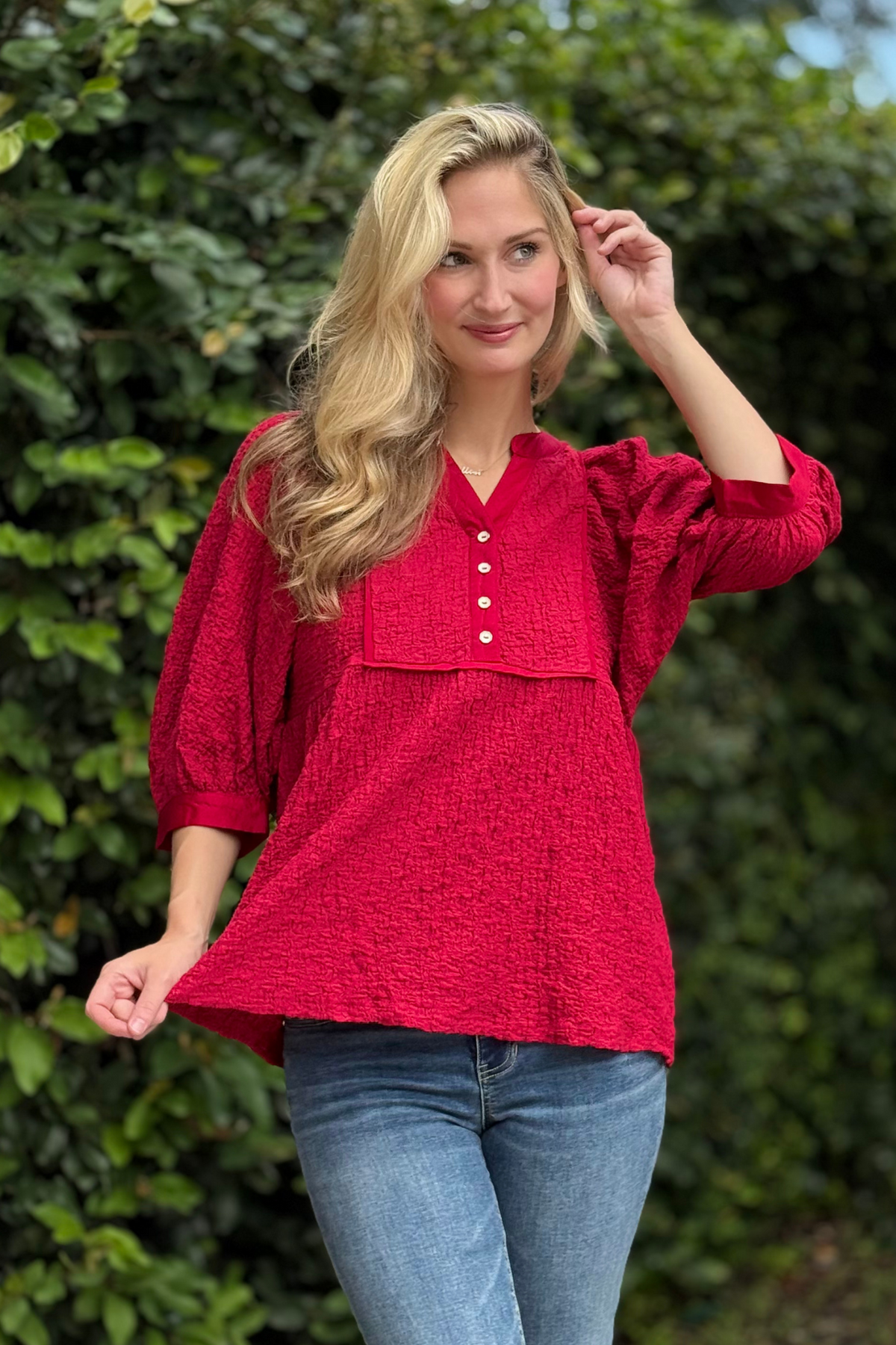 Highlight the blouse’s feminine, textured design, satin binding details, and relaxed babydoll silhouette. Convey versatile styling suitable for casual, office, or day-to-night looks.