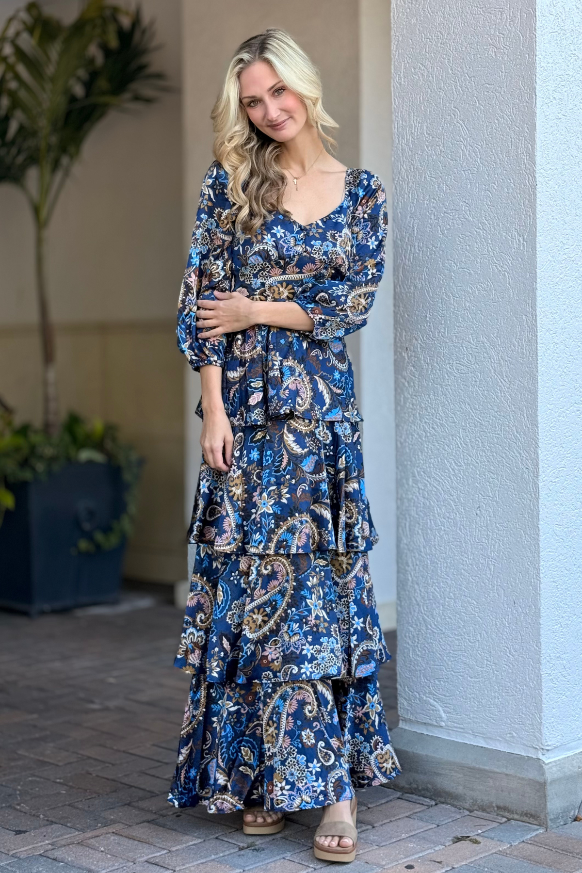 Model wearing navy paisley tiered maxi dress with sweetheart neckline