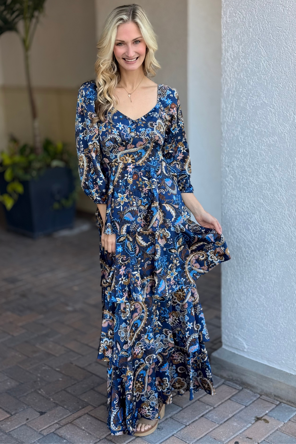Front view of tiered paisley maxi dress in navy blue