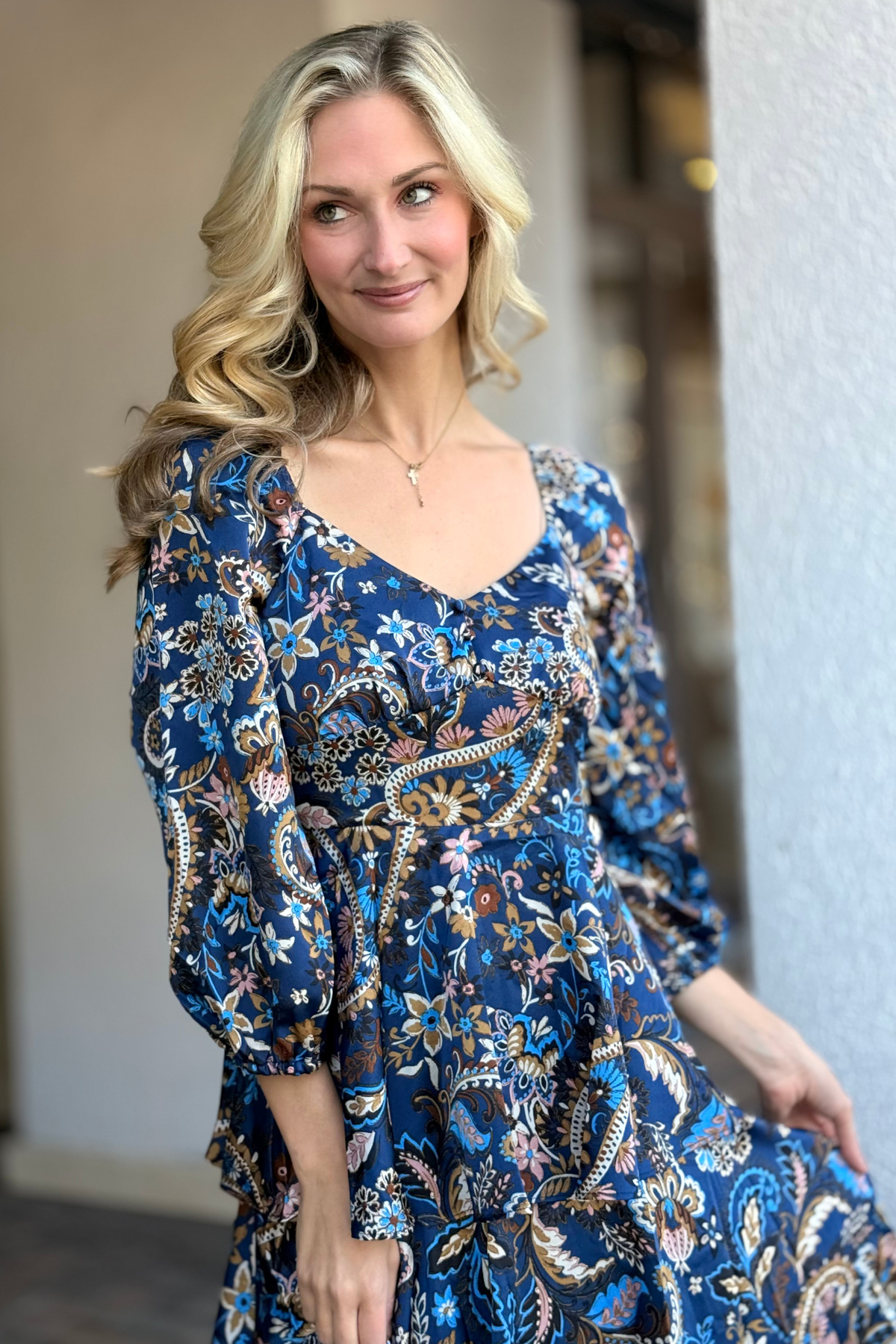 Close-up of sweetheart neckline and paisley print on maxi dress