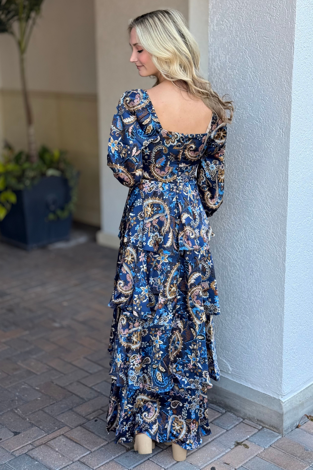 Navy satin paisley print dress with long sleeves and tiered hem