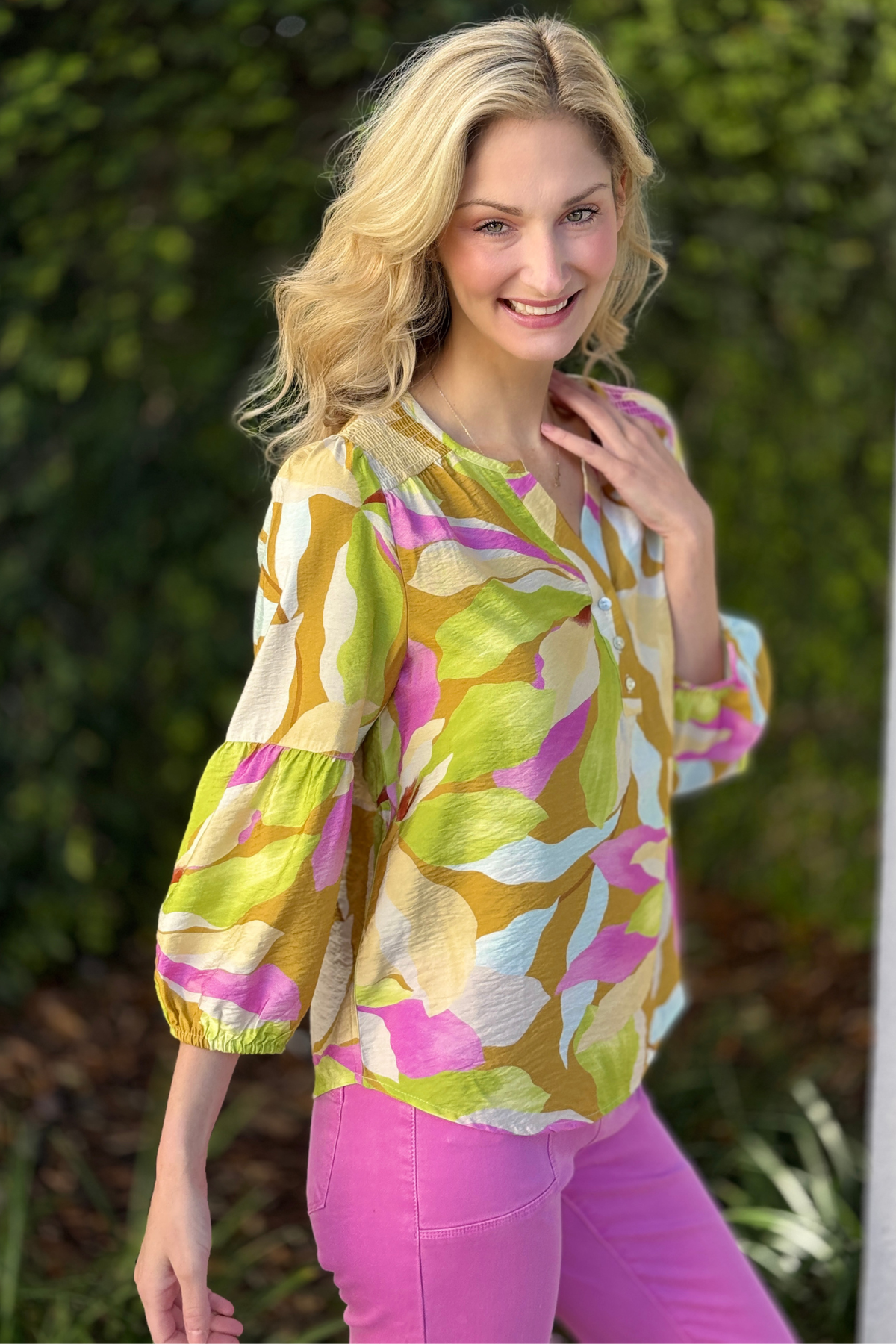 Model wearing tribal wisteria printed blouse with pink pants