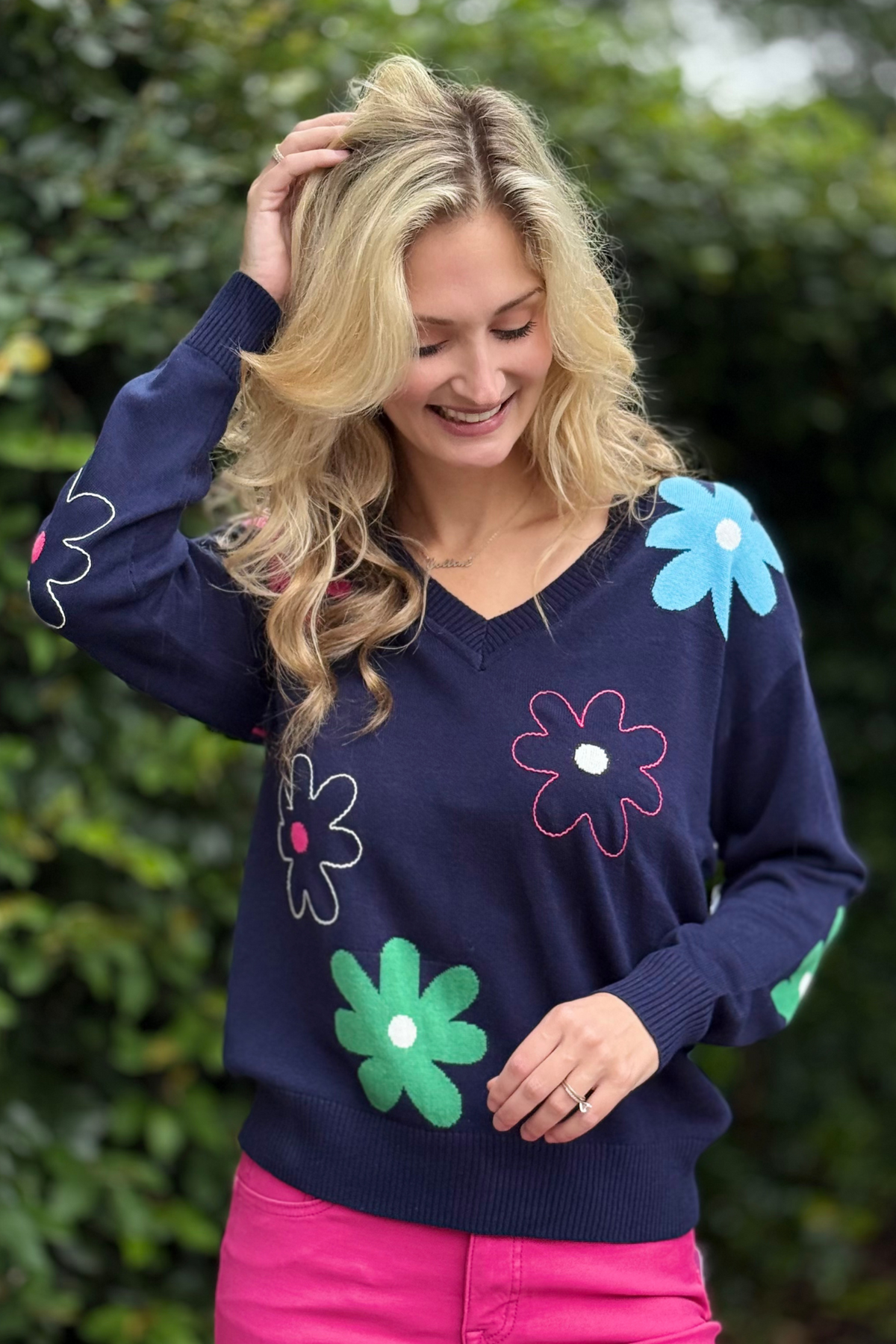 Model wearing the Tribal Nightfall Daisy V-Neck Sweater with embroidered flowers