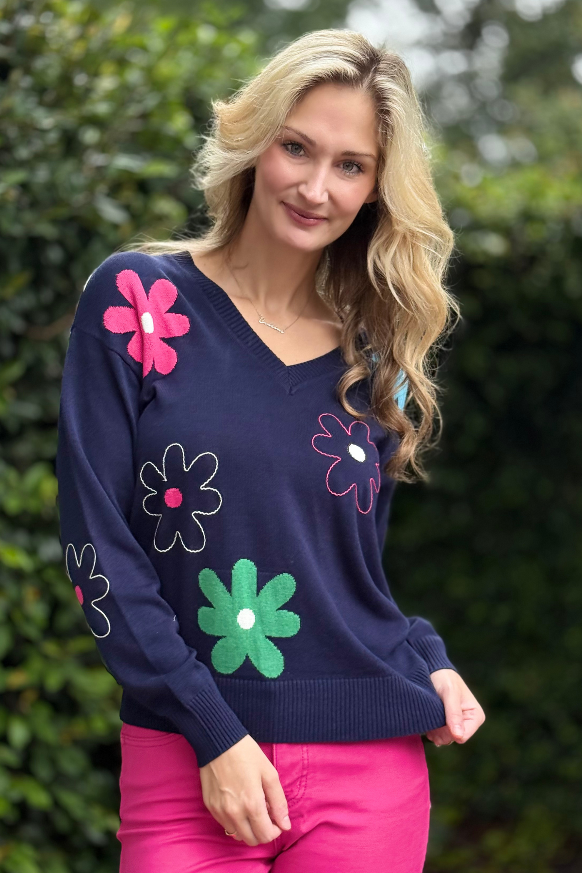 Close-up of daisy embroidery detail on cotton knit sweater