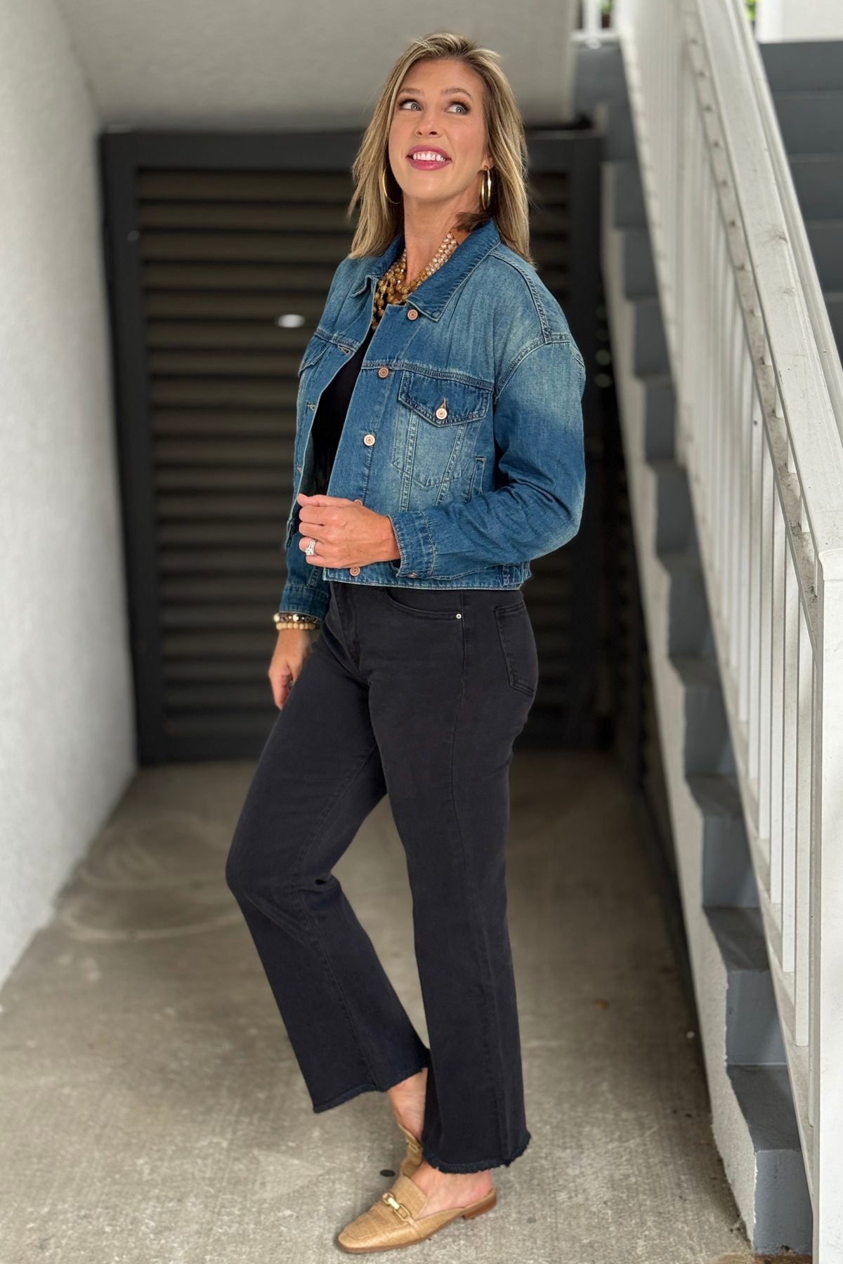 Back view of Fountain wash denim jacket with decorative back tabs and pleats.