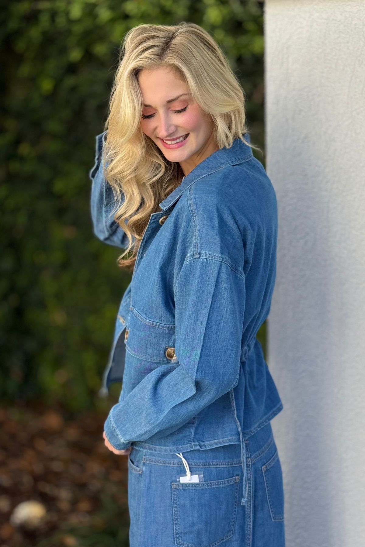 Back view of Tribal Fjord Blue denim jacket showing adjustable strap detail