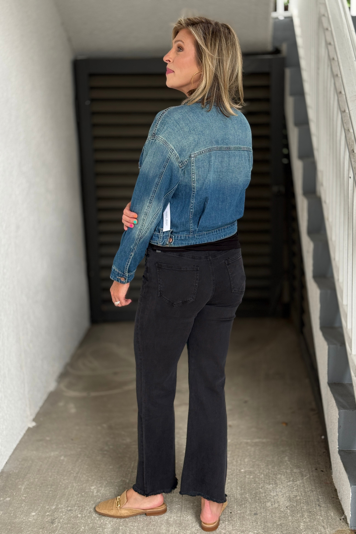 Women's cropped denim jacket by Tribal Clothing in a medium vintage blue wash.