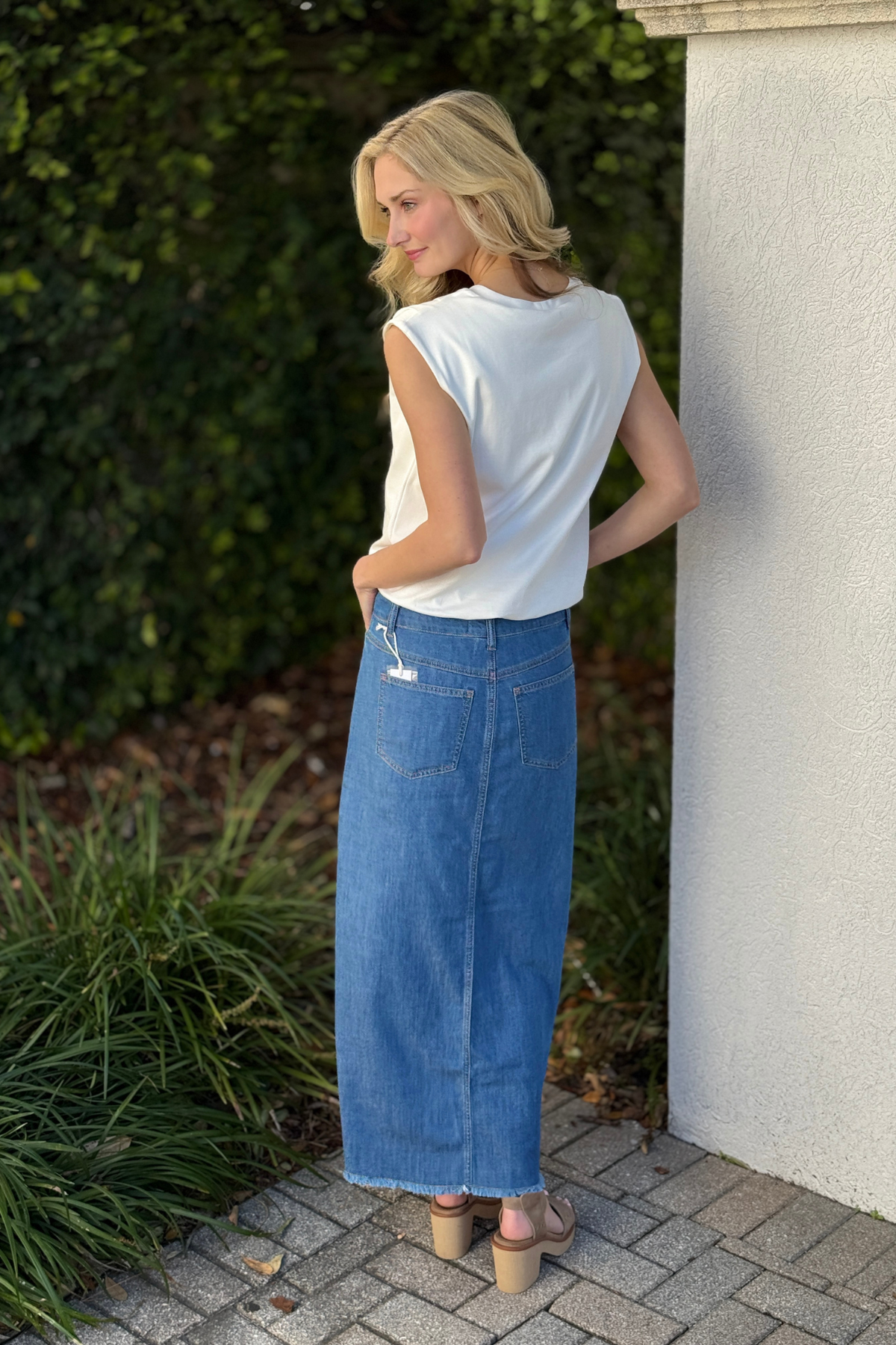 Side view of Tribal long fjord blue denim skirt showing front slit and frayed hem detail