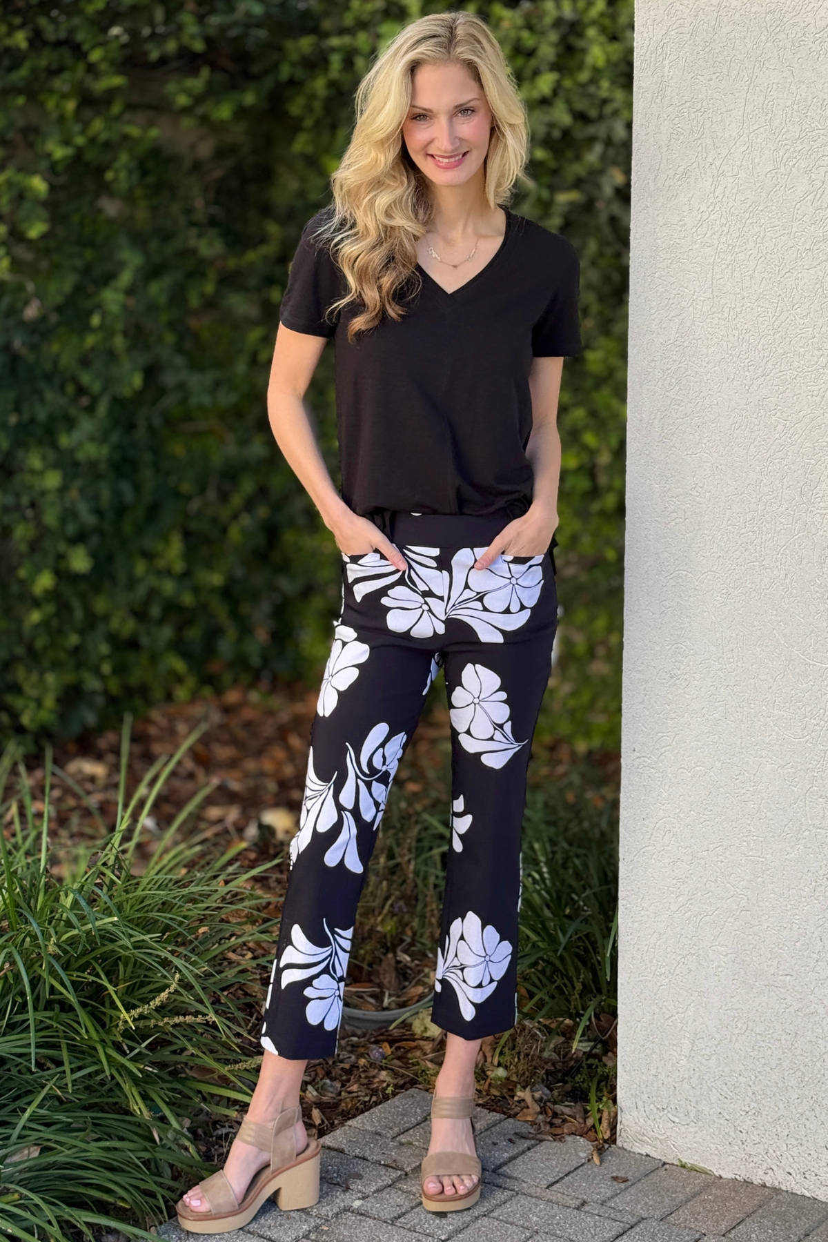 Black and white floral Tribal pull-on capri pants front view styled with black top