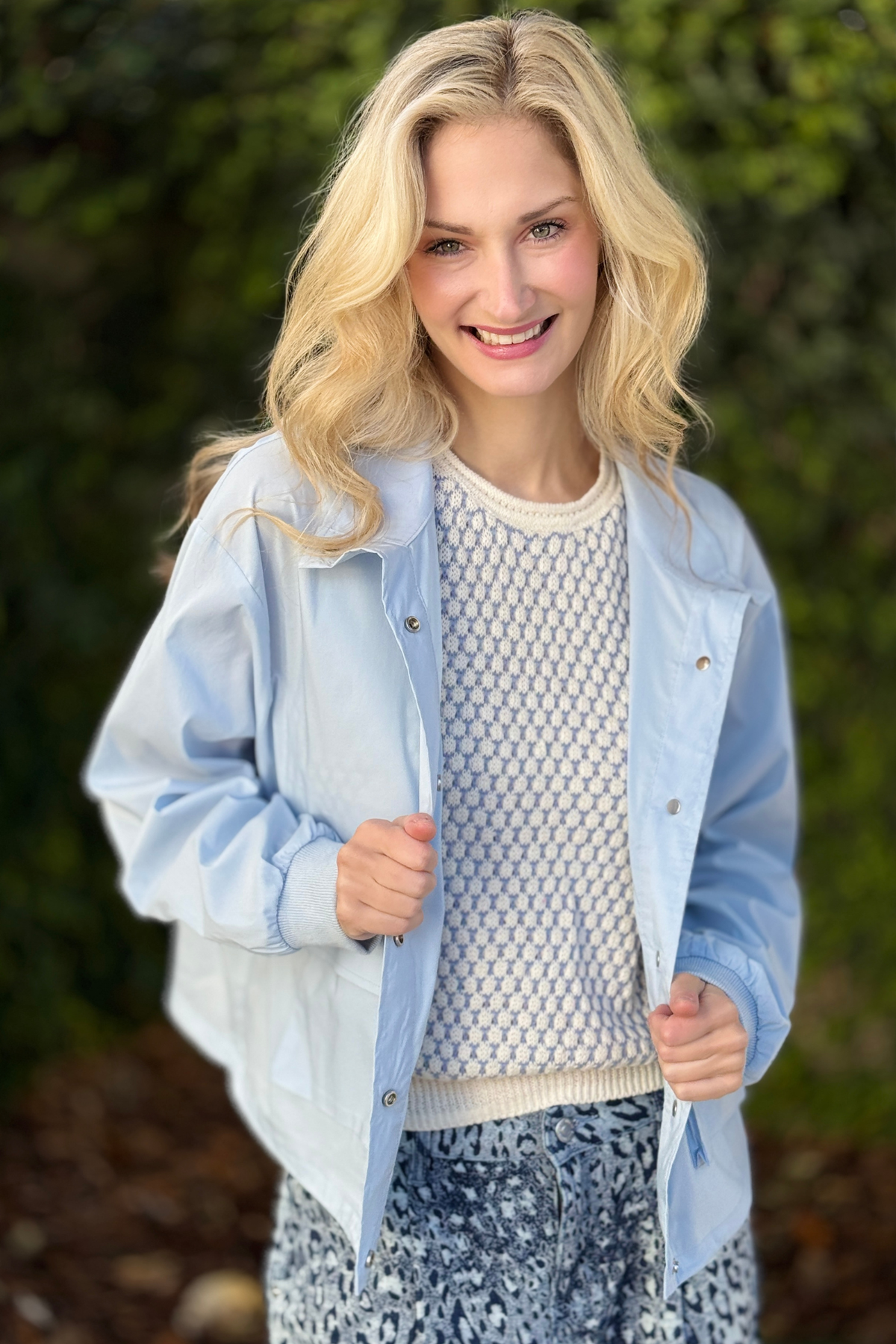 Woman wearing Tribal saltwater blue lightweight windbreaker jacket styled with printed denim