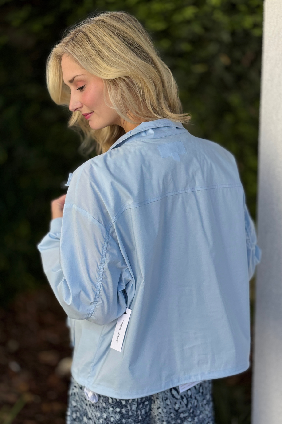 Close view of Tribal saltwater windbreaker jacket highlighting adjustable waist and front pockets