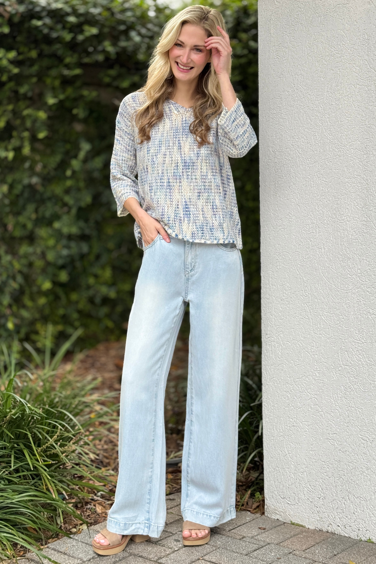 Light wash wide leg jeans styled with knit top