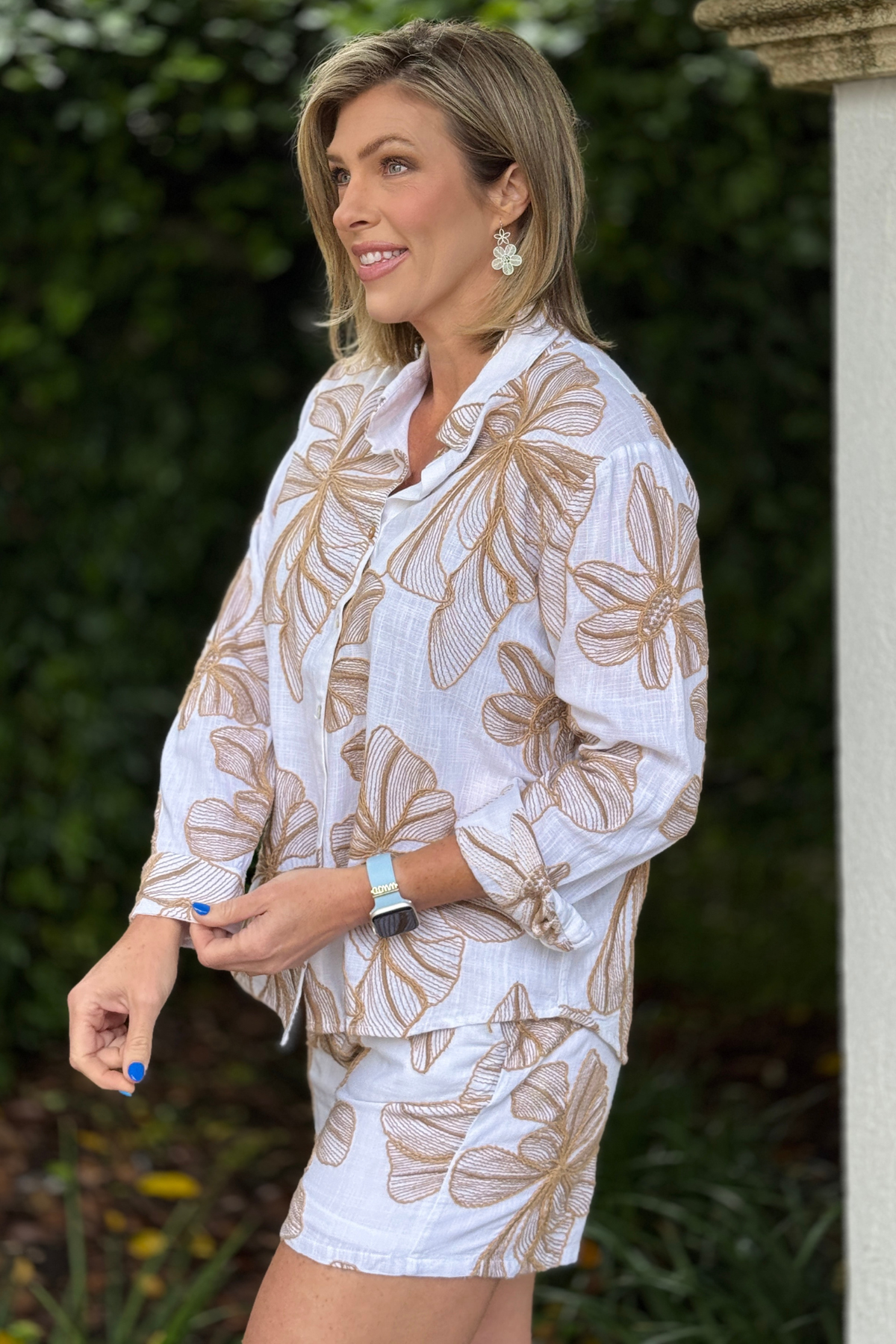 Side view of embroidered summer blouse with rolled sleeves