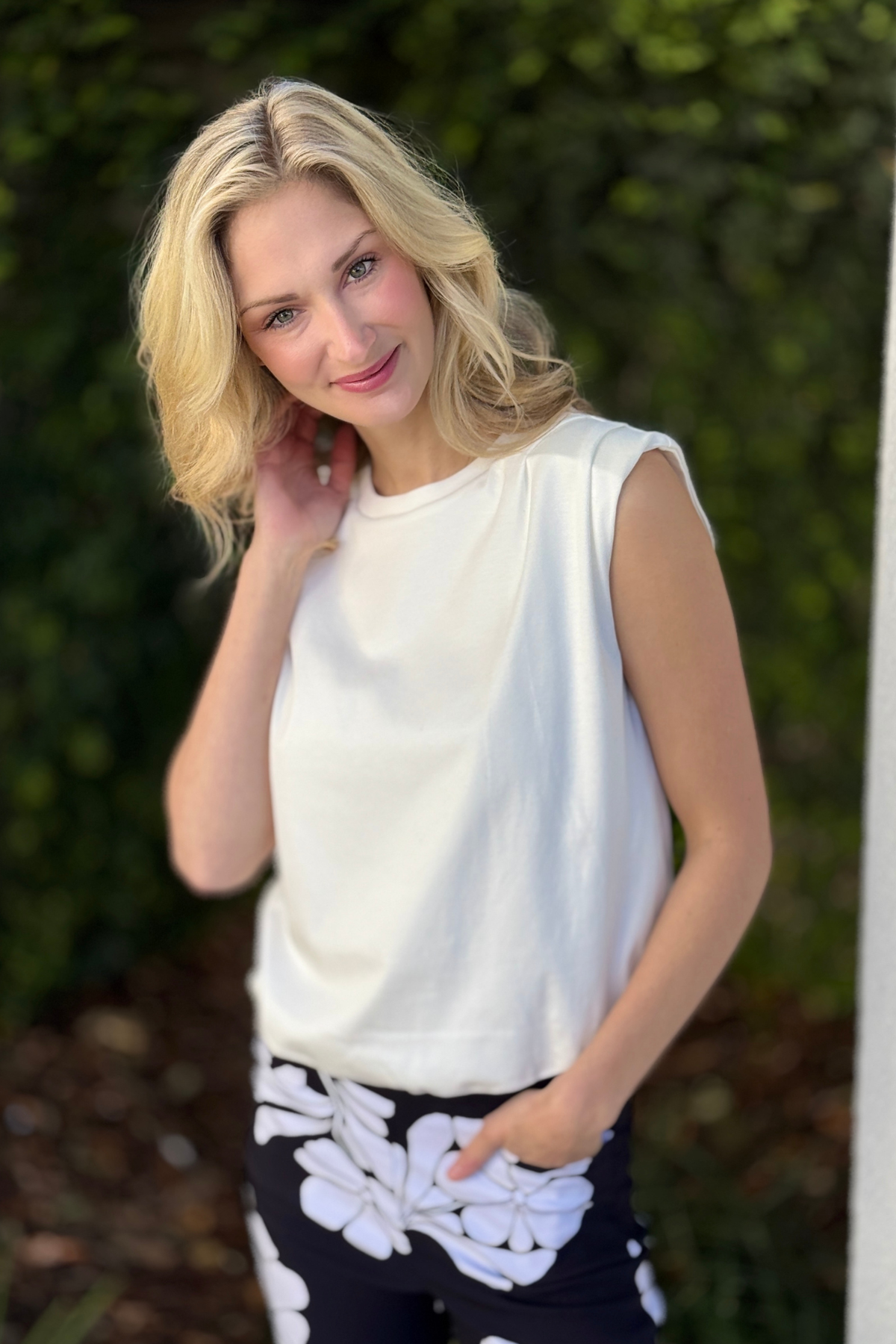 White padded shoulder muscle tee styled with printed black and white pants