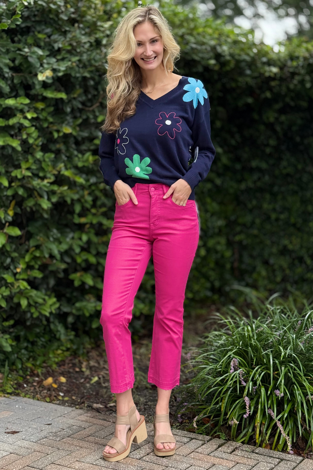 Model wearing Tribal Cherry Pop Sophia Micro Flare Crop Jean in bright cherry pink