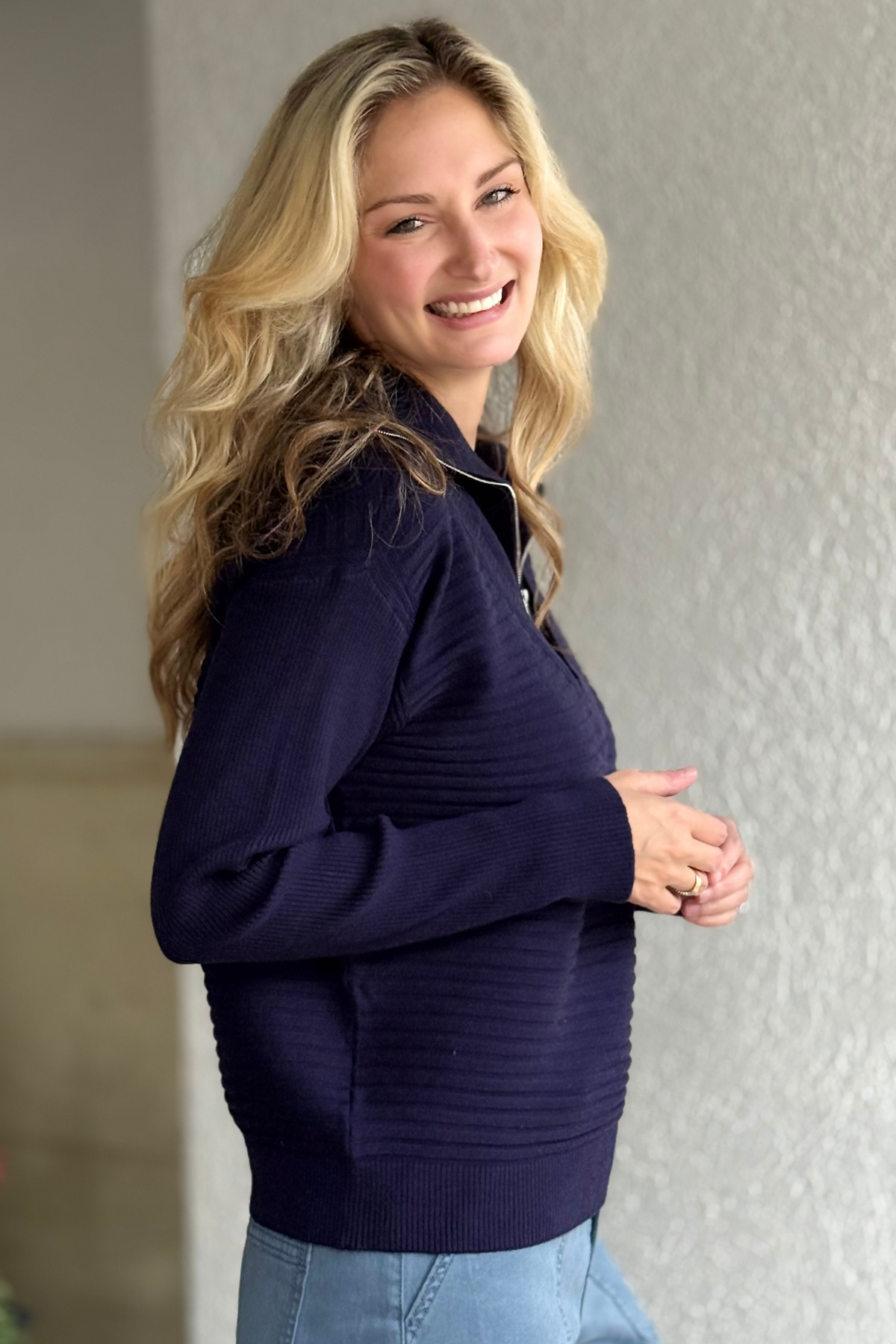 Relaxed drop-shoulder navy sweater styled for fall