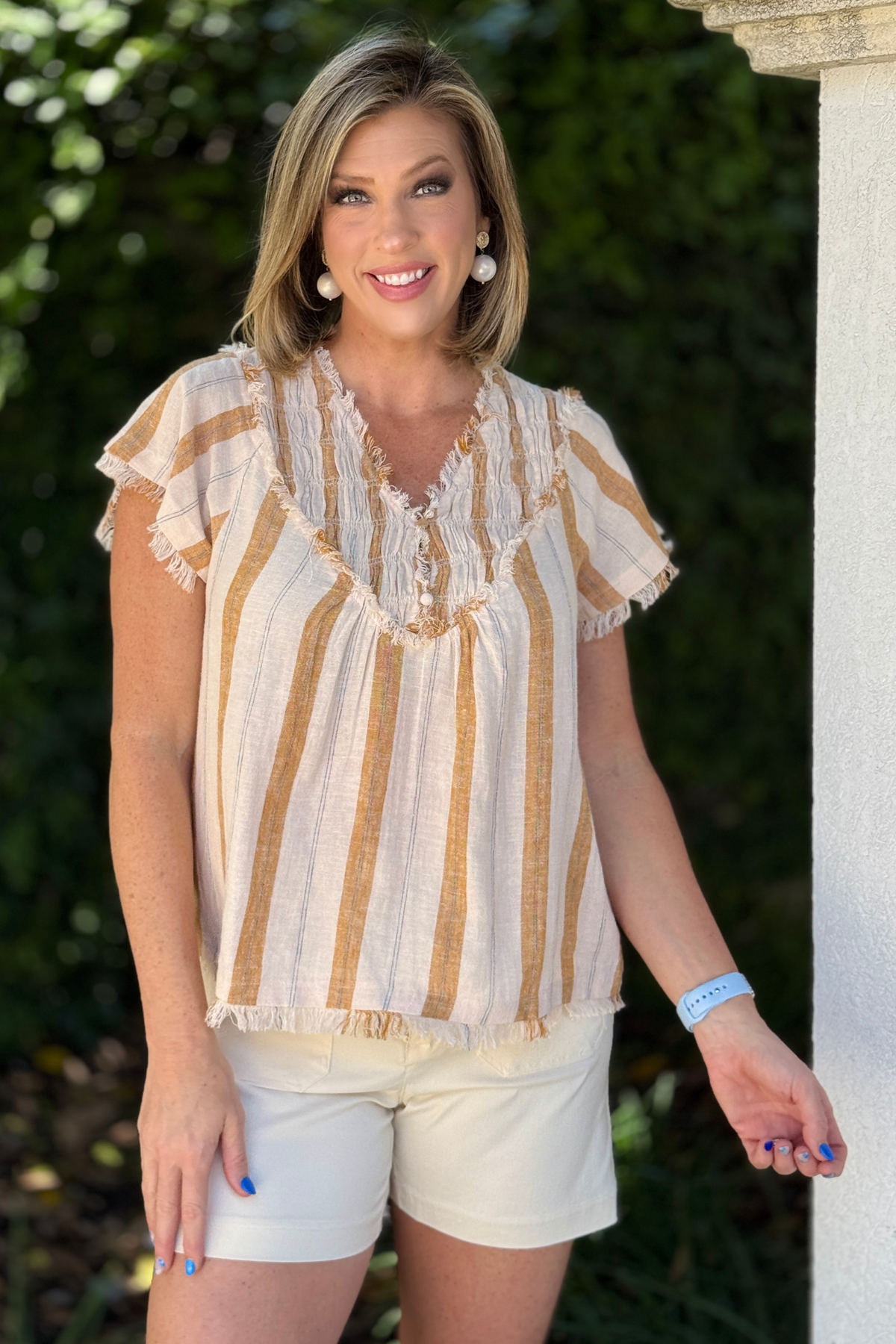 Back view of striped linen blouse with subtle texture and flowy silhouette