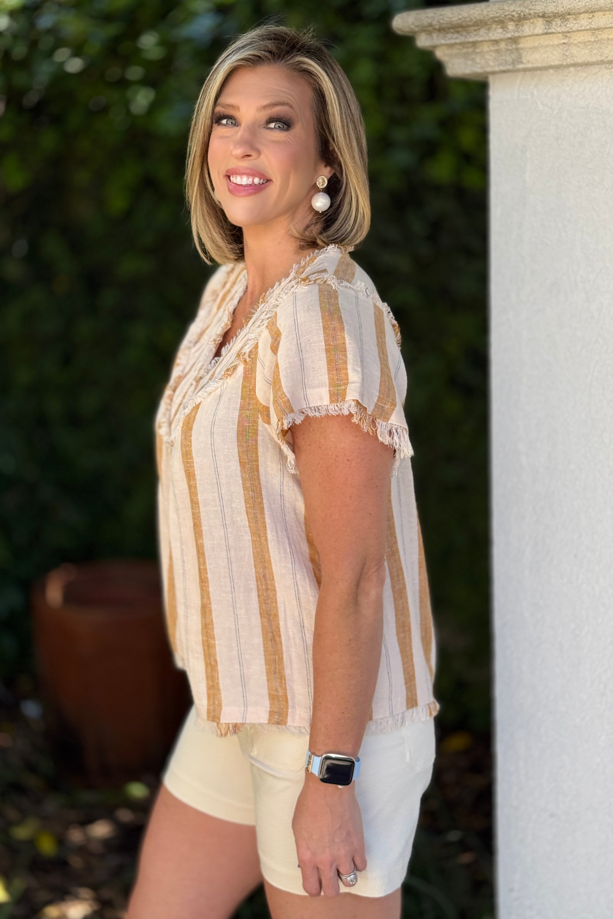 Casual summer outfit with linen stripe blouse and tailored shorts