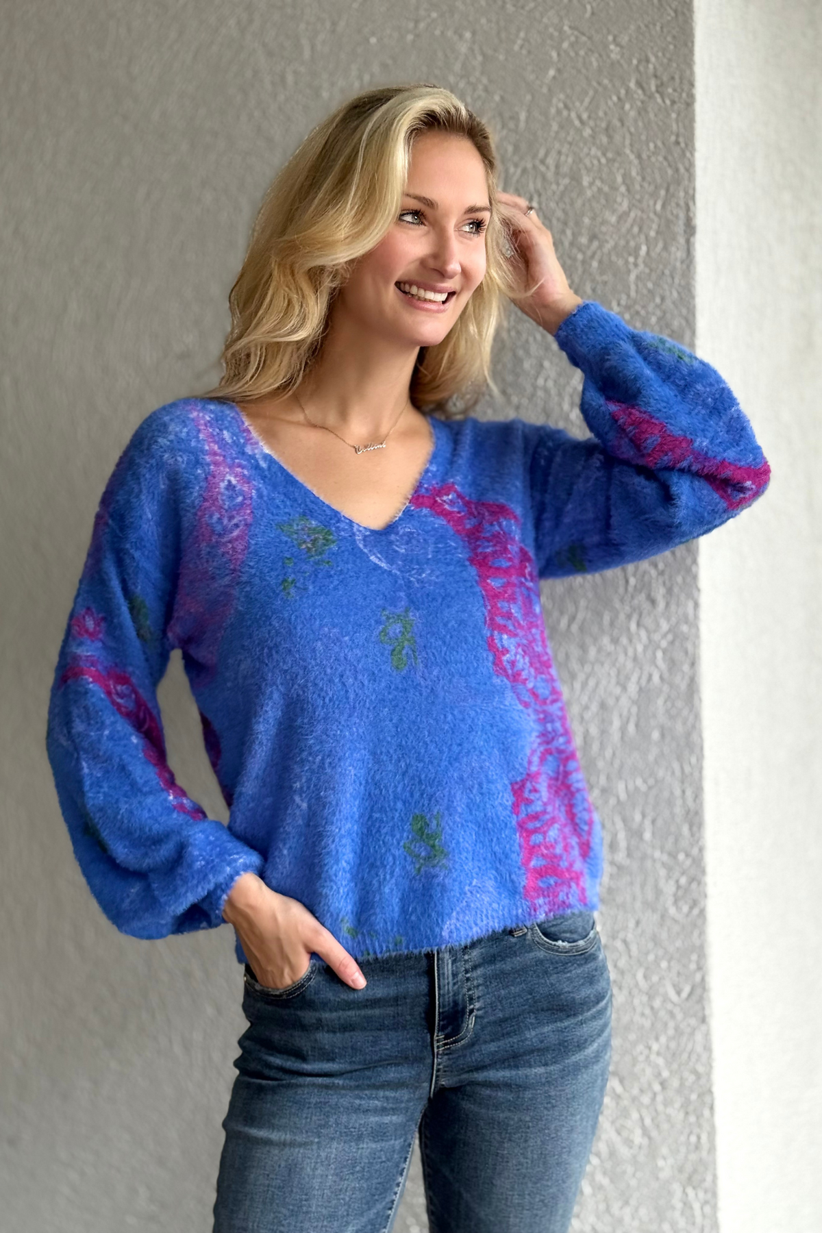Model wearing Tribal Lapis Bloom Reversible Sweater in lapis blue with floral print