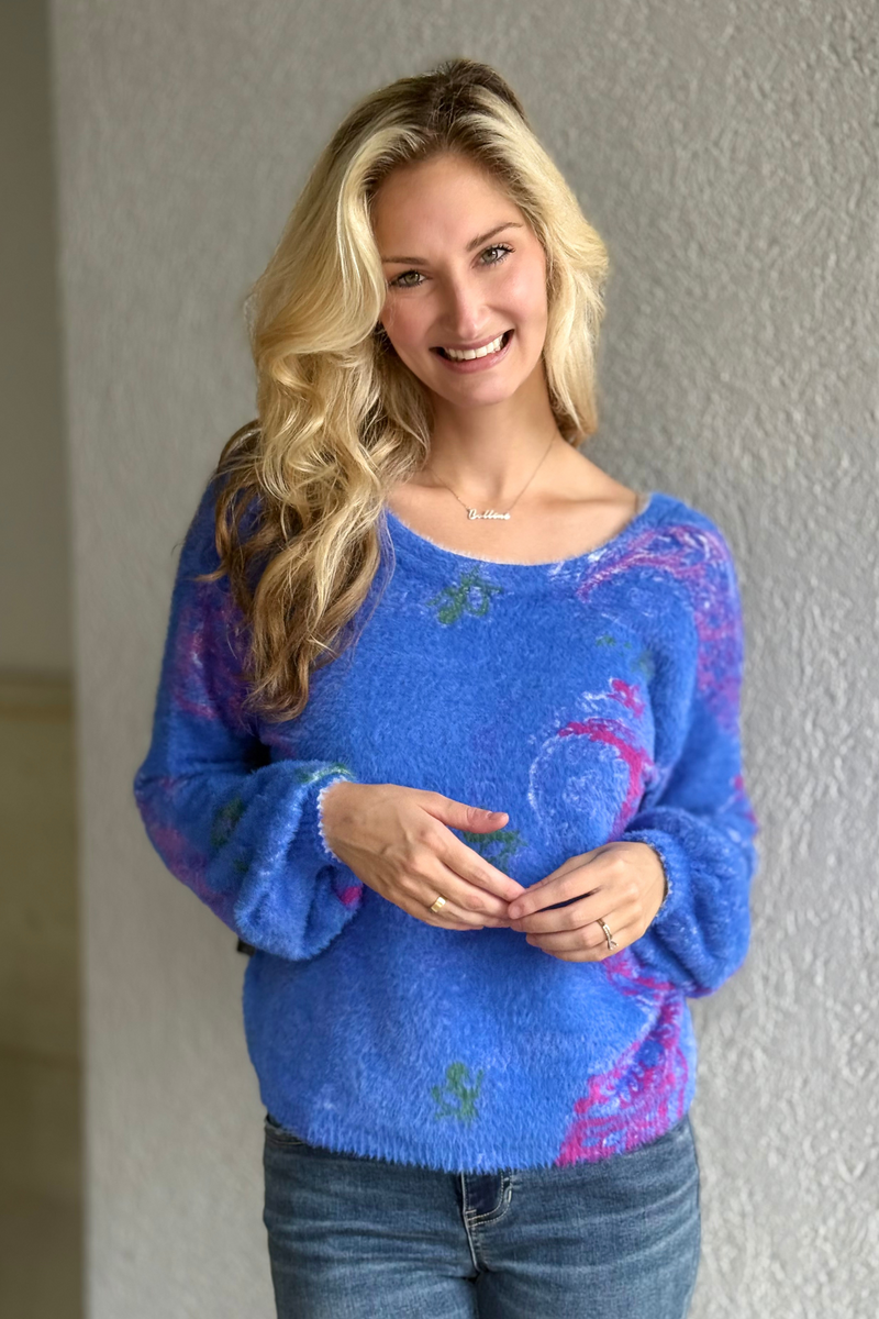 Close-up of eyelash yarn floral sweater with bishop sleeves