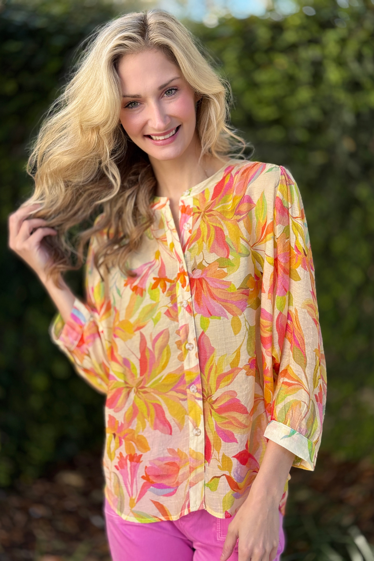 Model wearing tribal rosesilk blouse styled with pink pants