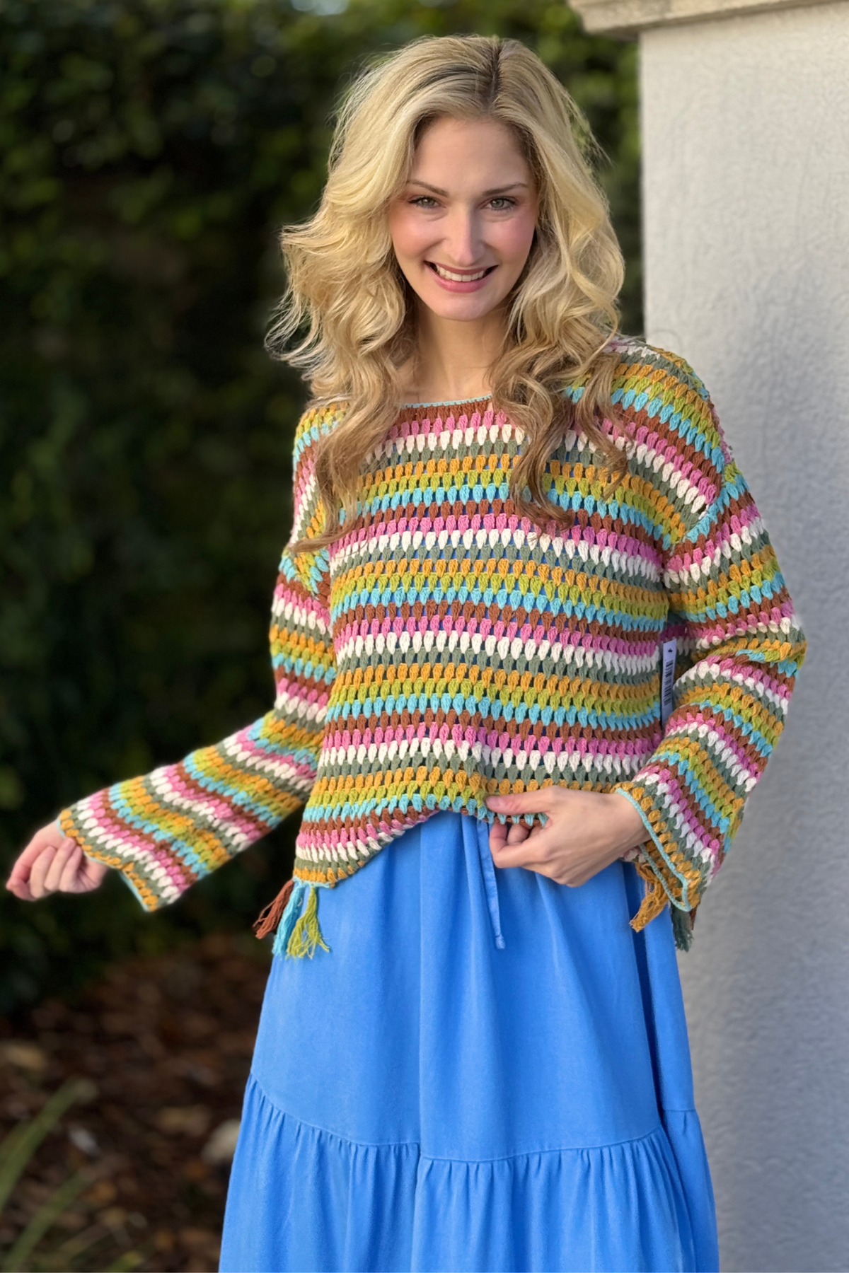 Close up of tassel detail tribal crochet sweater