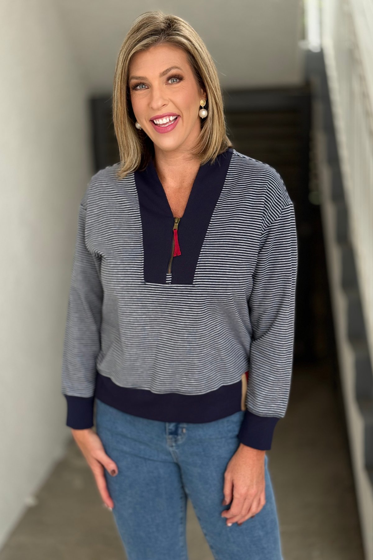 Side view of navy striped shawl collar sweatshirt for women