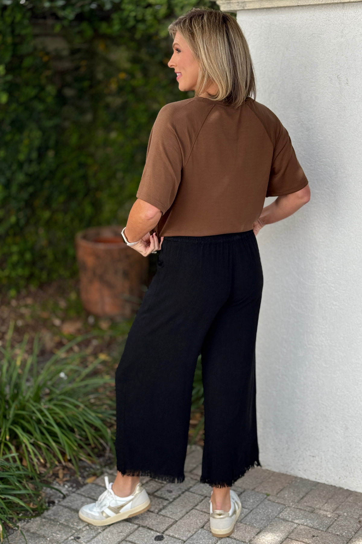 Black pull-on pants with raw frayed hem