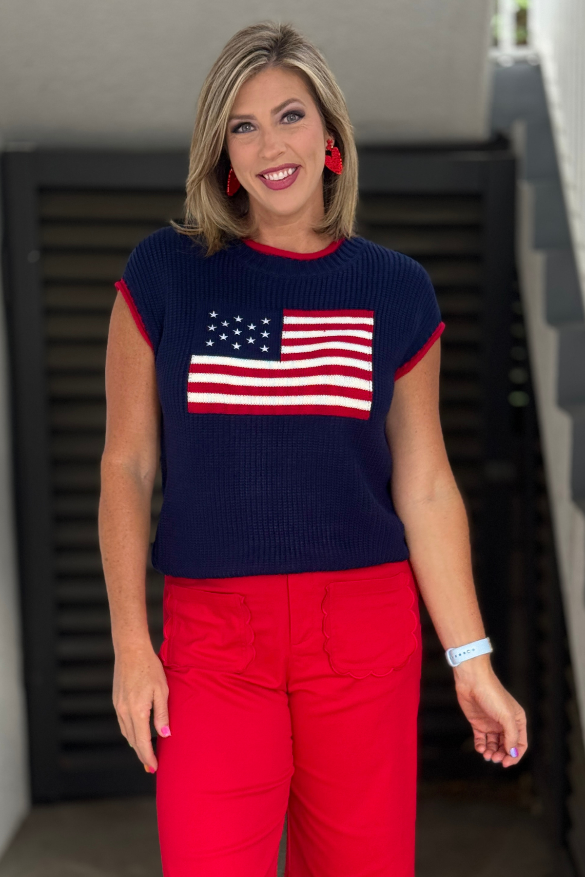 Americana sweater vest styled with bright red pants