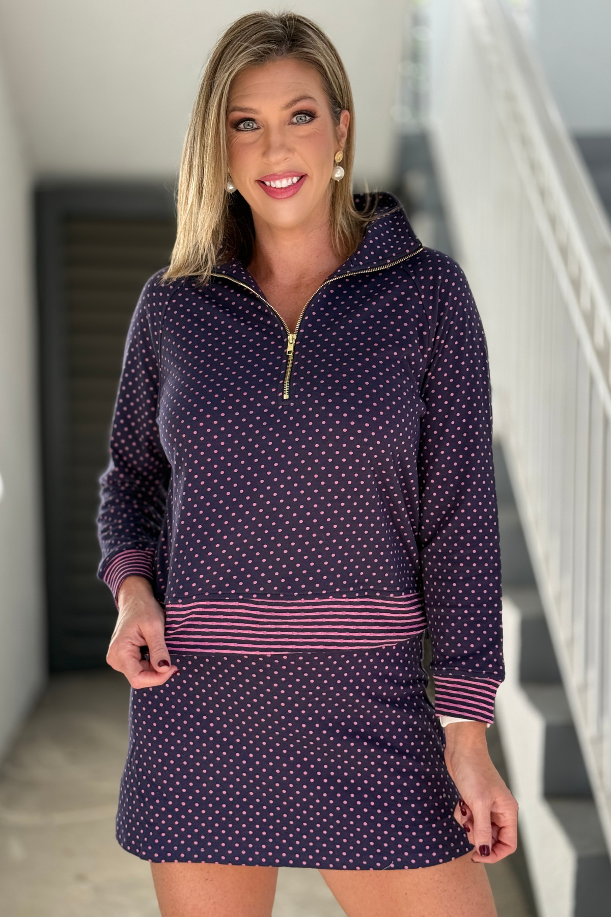 Navy polka dot pullover with pink striped trim