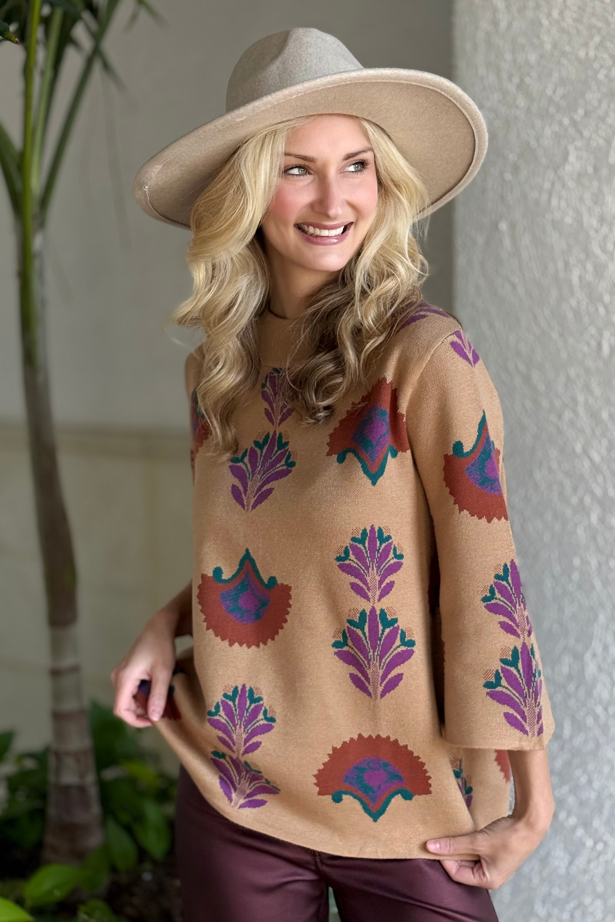 Umgee cozy floral sweater styled with burgundy pants and wide brim hat