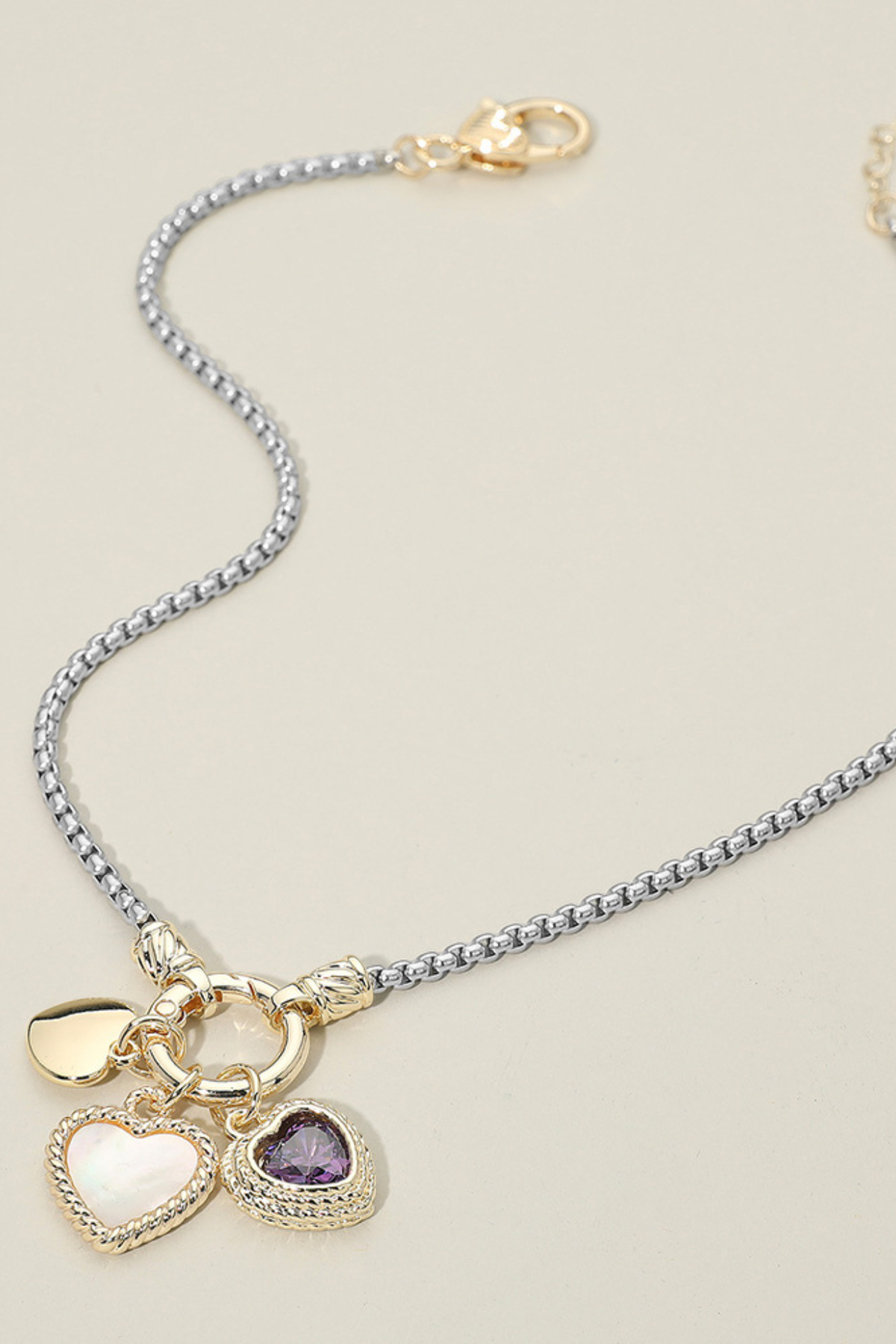 Gold dipped heart pendant necklace featuring multiple charms