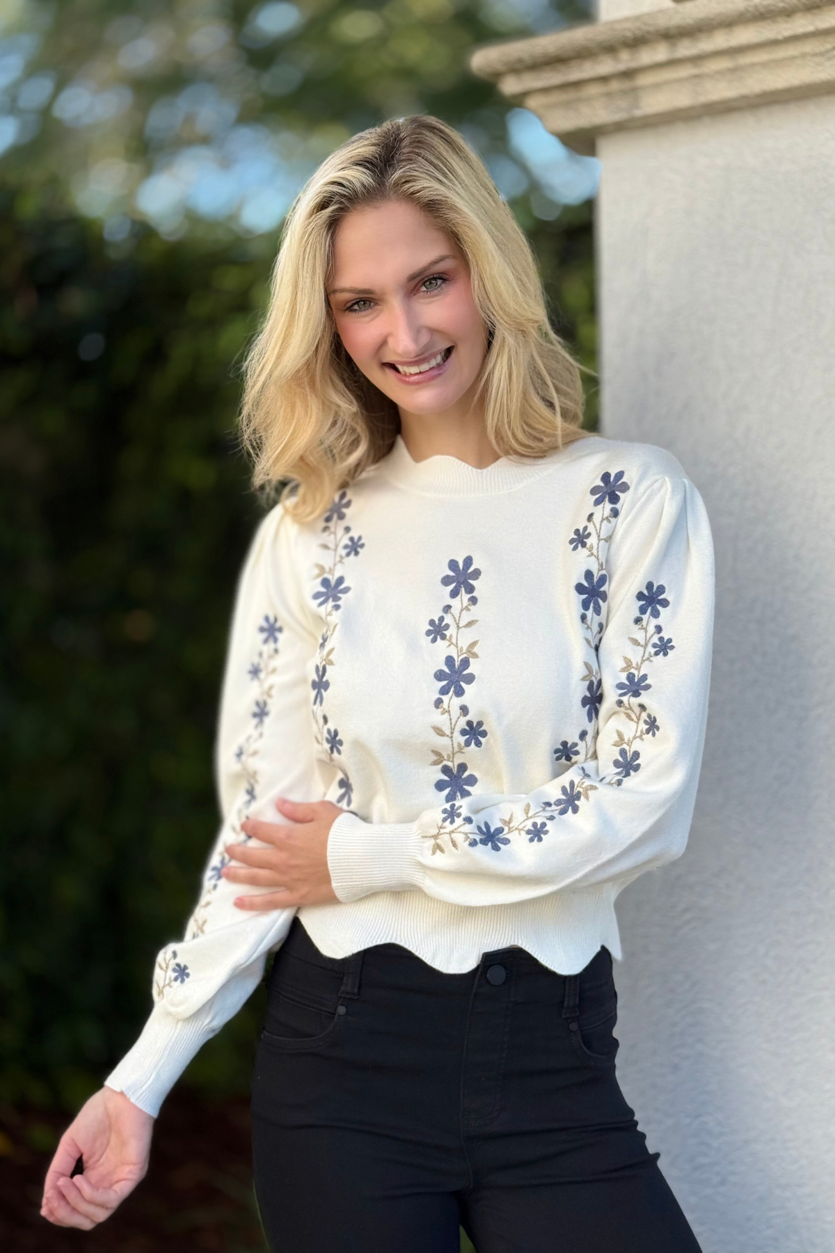 Woman wearing white floral embroidered scallop hem cropped sweater
