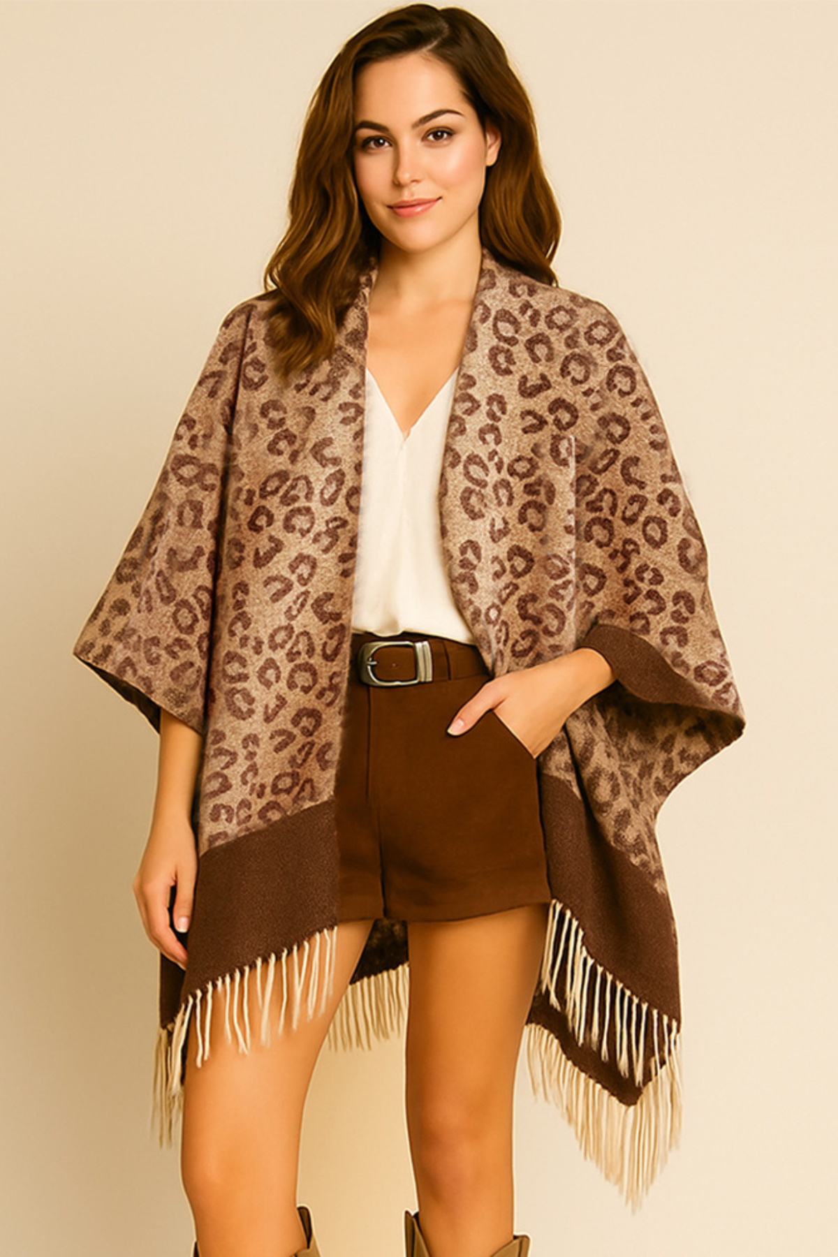 Leopard print open front fringe poncho with brown border and tassel hem.