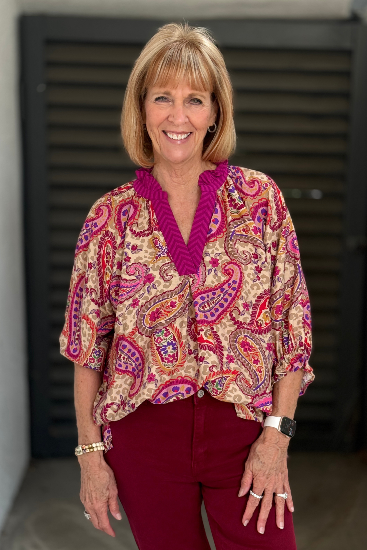 Colorful paisley print boho blouse with contrast V-neck.